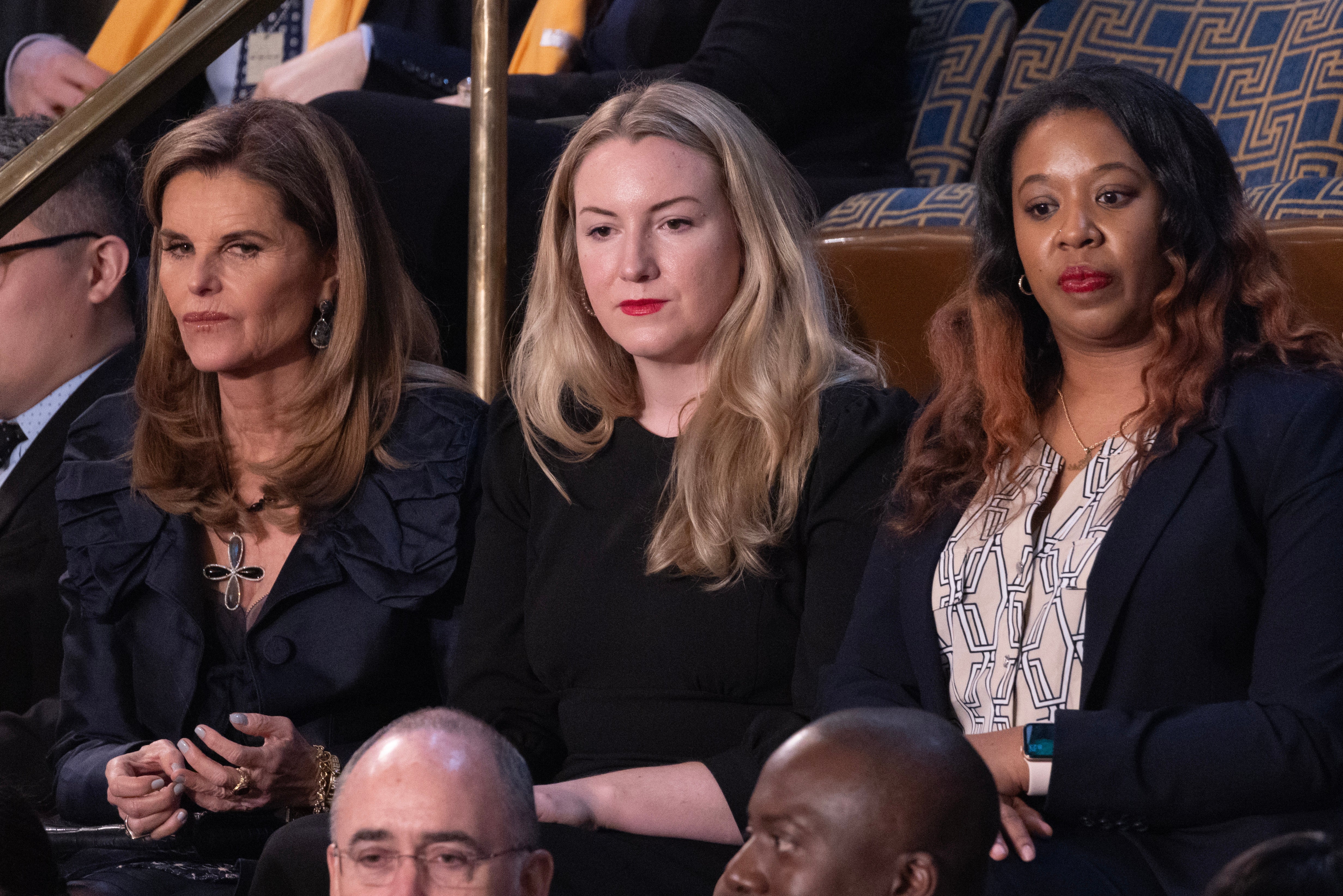 Women’s health advocate Maria Shriver (L); Texas mother of two who fought a legal battle after being denied an abortion, Kate Cox (C); and Latorya Beasley (R) of Alabama whose embryo transfer was canceled as a result of the recent Alabama Supreme Court decision; sit in the House chamber before US President Joe Biden delivers his State of the Union address before a joint session of Congress on the floor of the US House of Representatives, on Capitol Hill