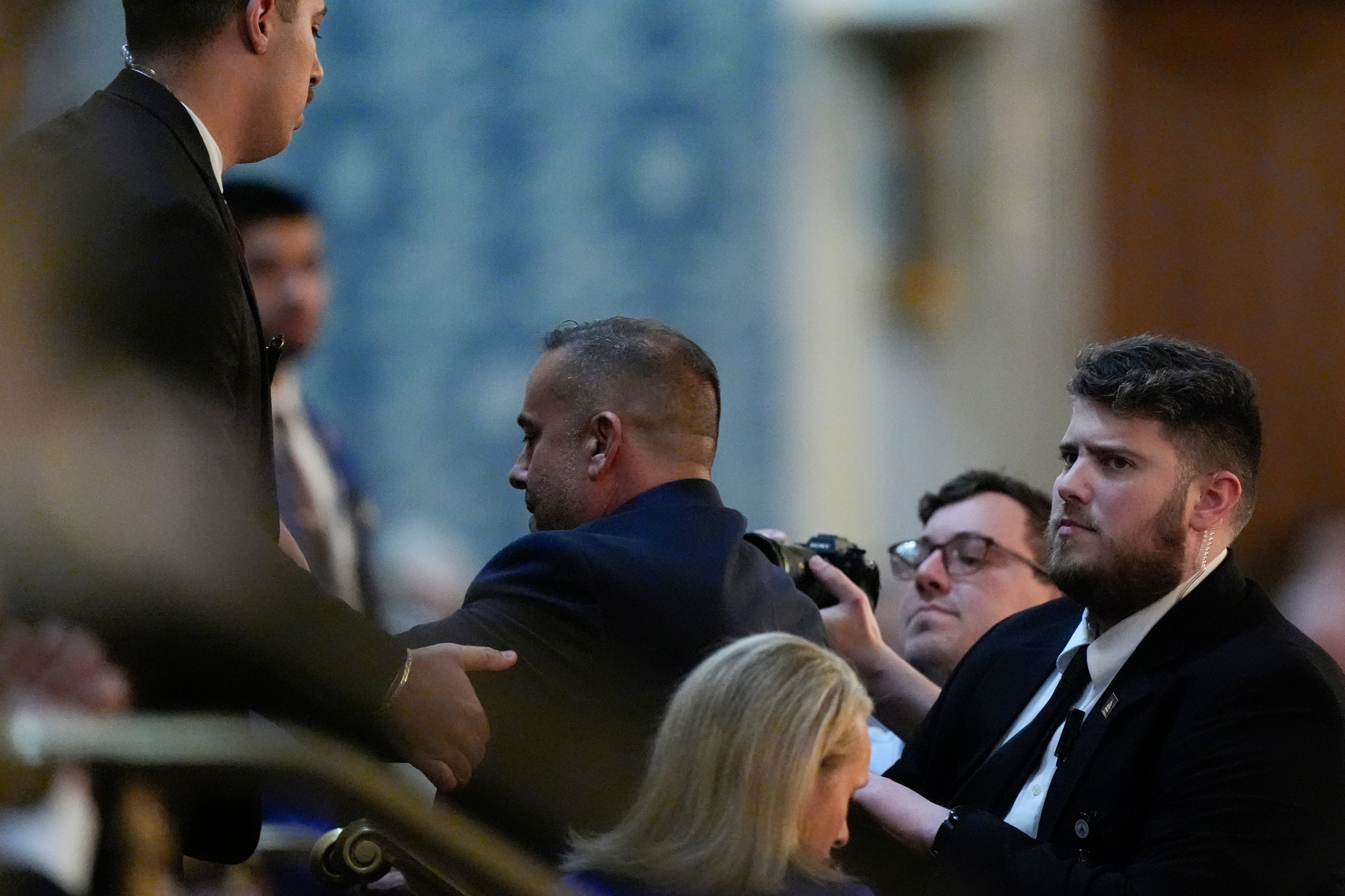 A protester is escorted out by security