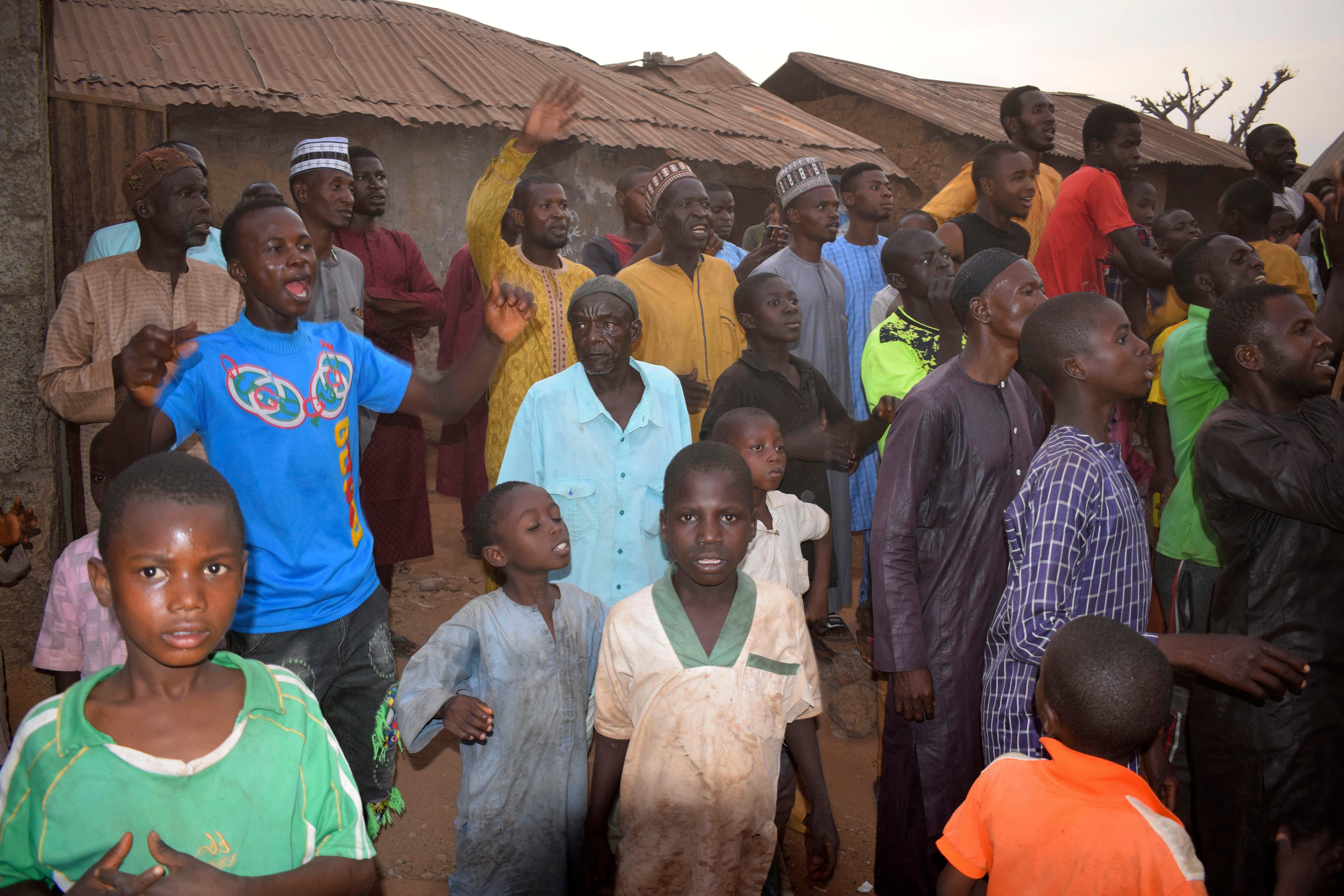 People gather around an area were gunmen kidnapped school children in Chikun, Nigeria, Thursday, 7 March 2024