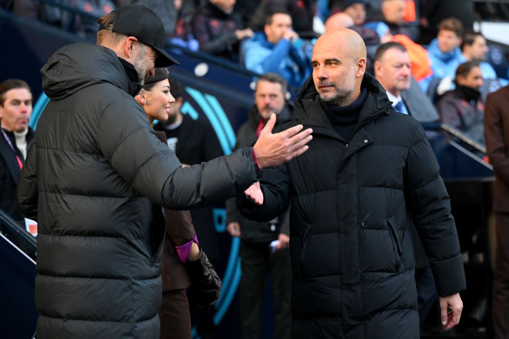 Jurgen Klopp and Pep Guardiola shake hands on the touchline