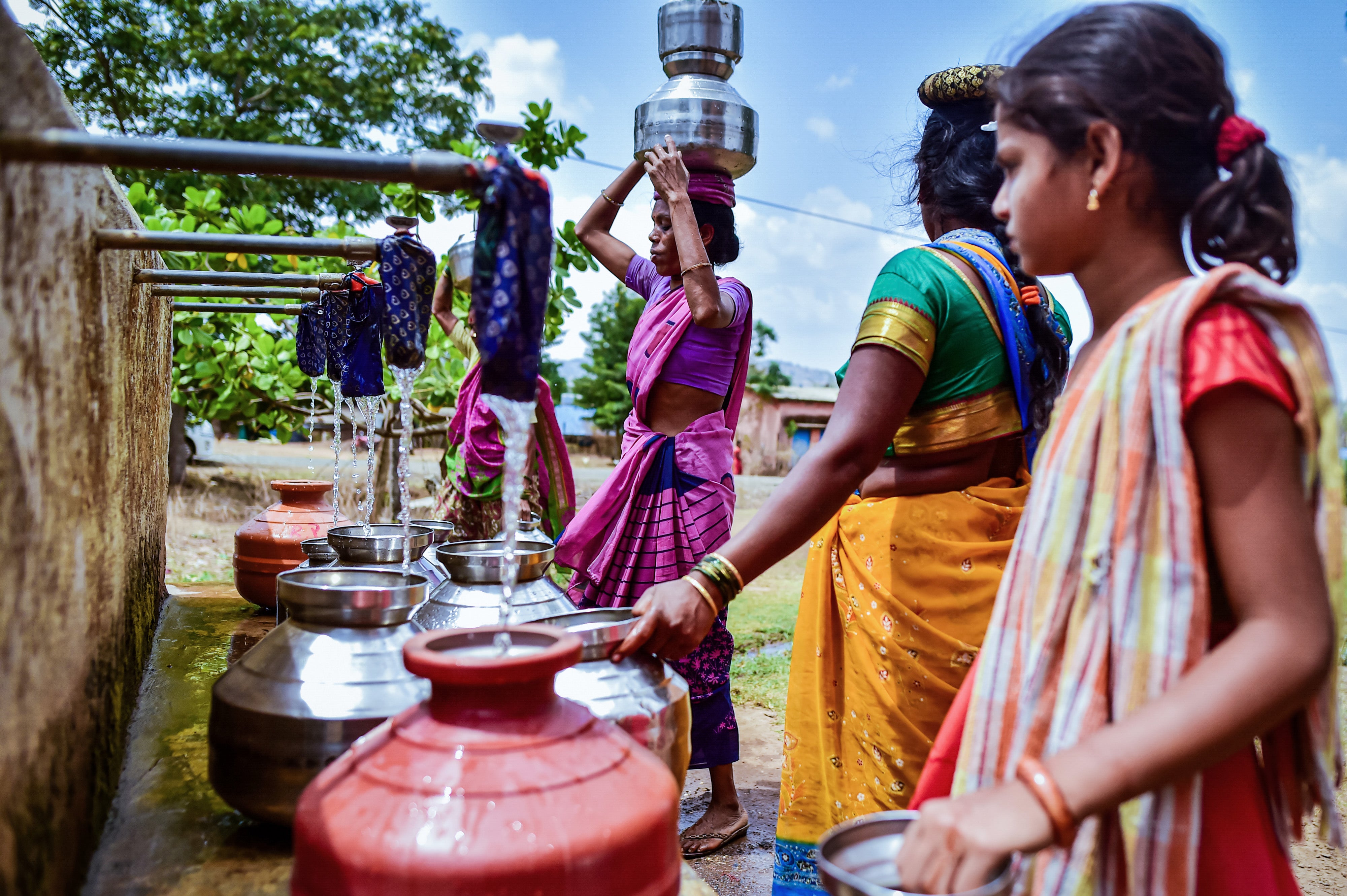 Women fill water from a municipal tank in Peth Taluka village, Nashik, Maharashtra