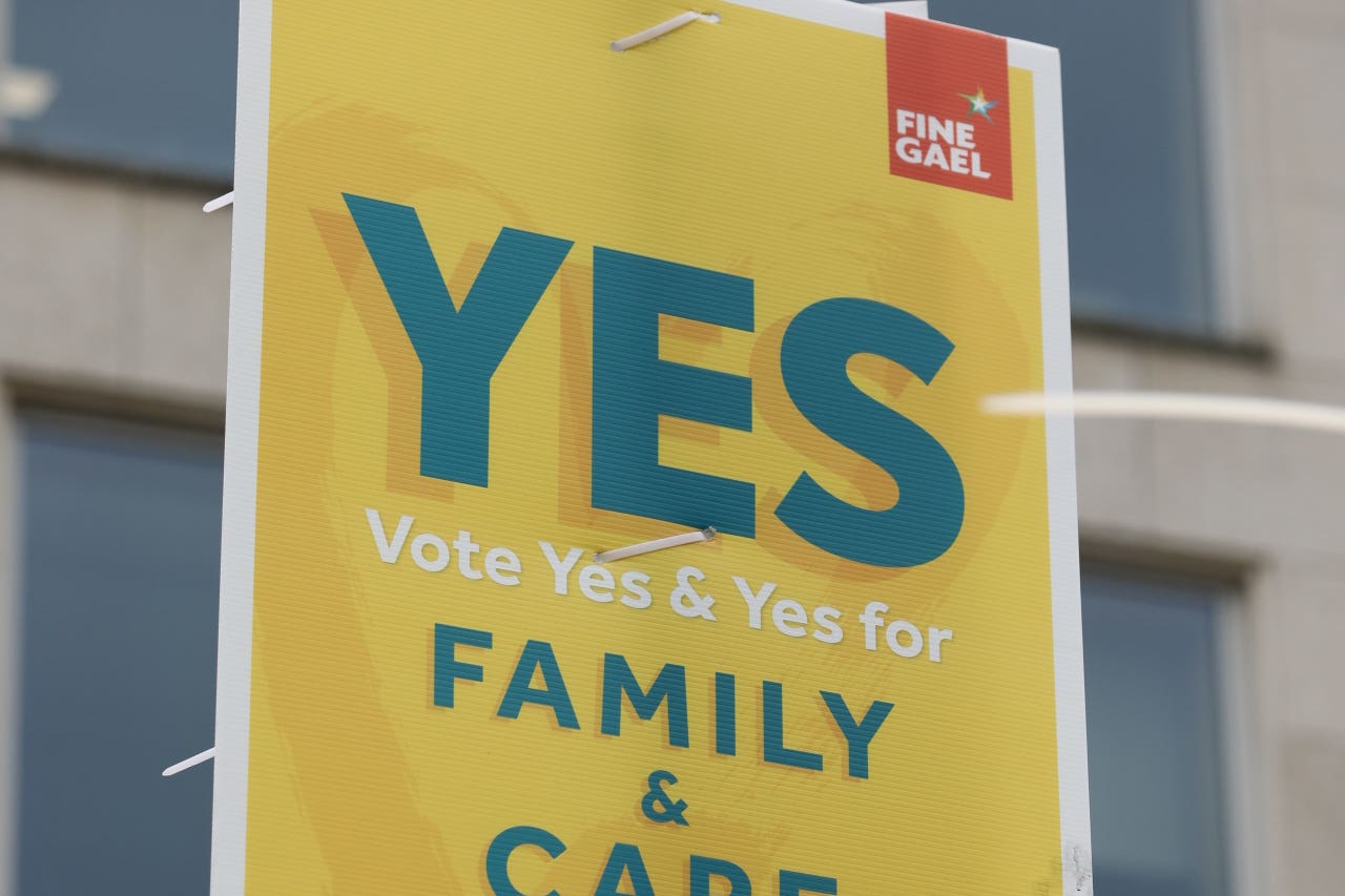 Placards in Dublin, as Ireland holds referenda on the proposed changes to the wording of the Constitution relating to the areas of family and care (Gareth Chaney/PA)