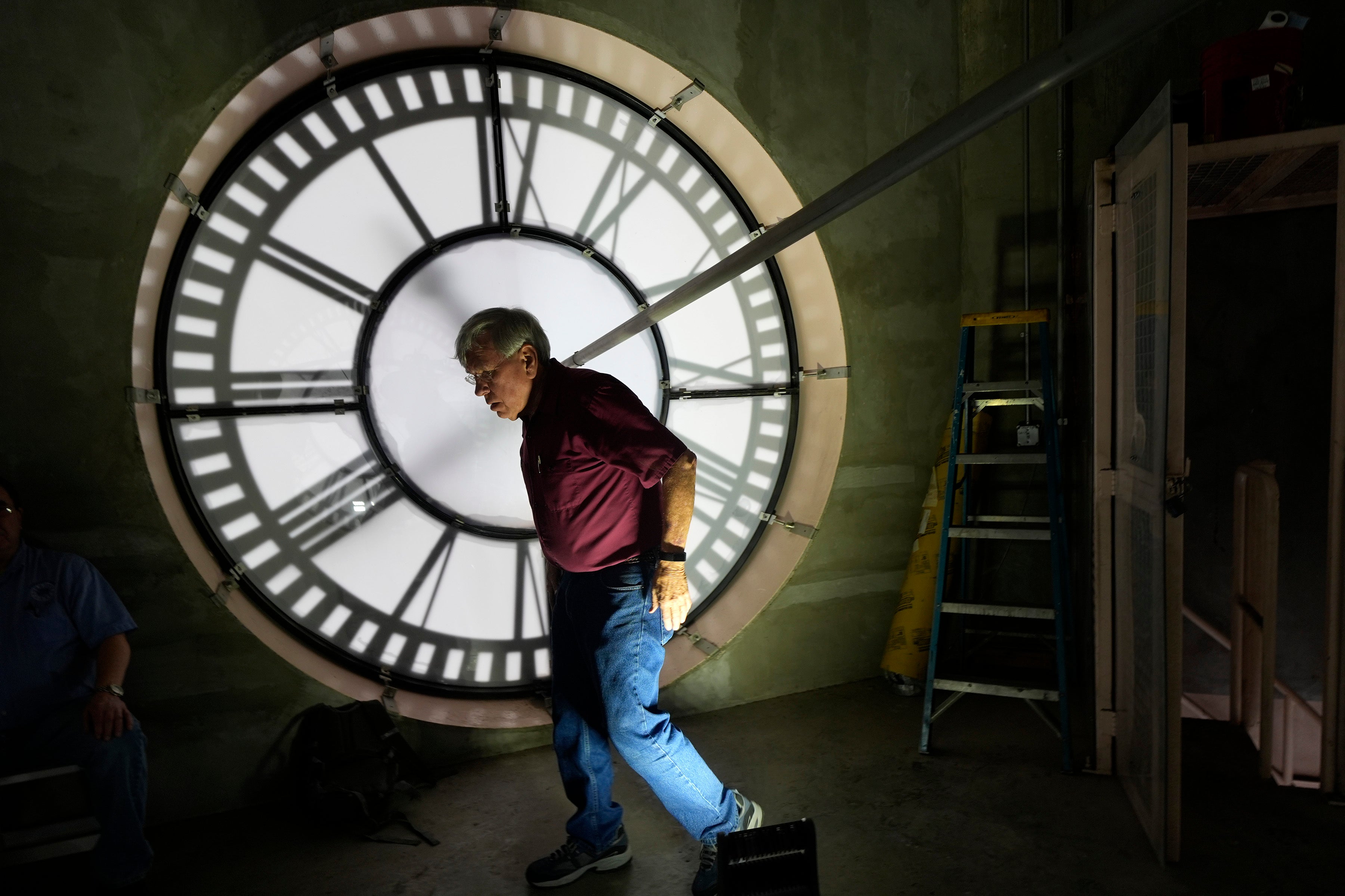 Don Bugh walks inside the historic clock tower atop the Dallas County Courthouse, Thursday, March 7, 2024, in Dallas. The mechanical clock built in 1890 requires hand lubrication and reseting twice a year with daylight savings time. (AP Photo/LM Otero)