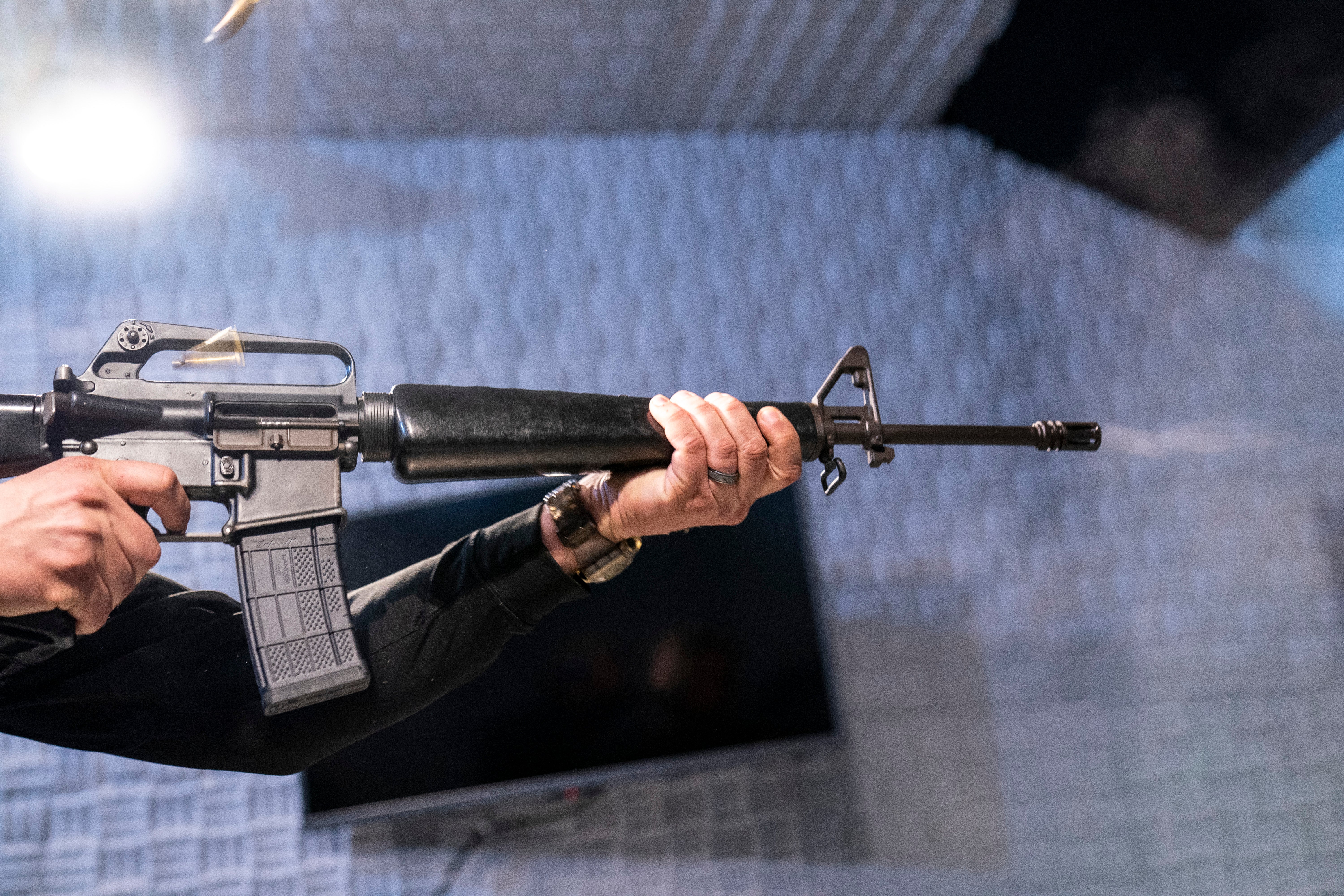 Two empty shell casings fly as a fully automatic M-16 is fired at the Bureau of Alcohol, Tobacco, Firearms, and Explosives (ATF), National Services Center