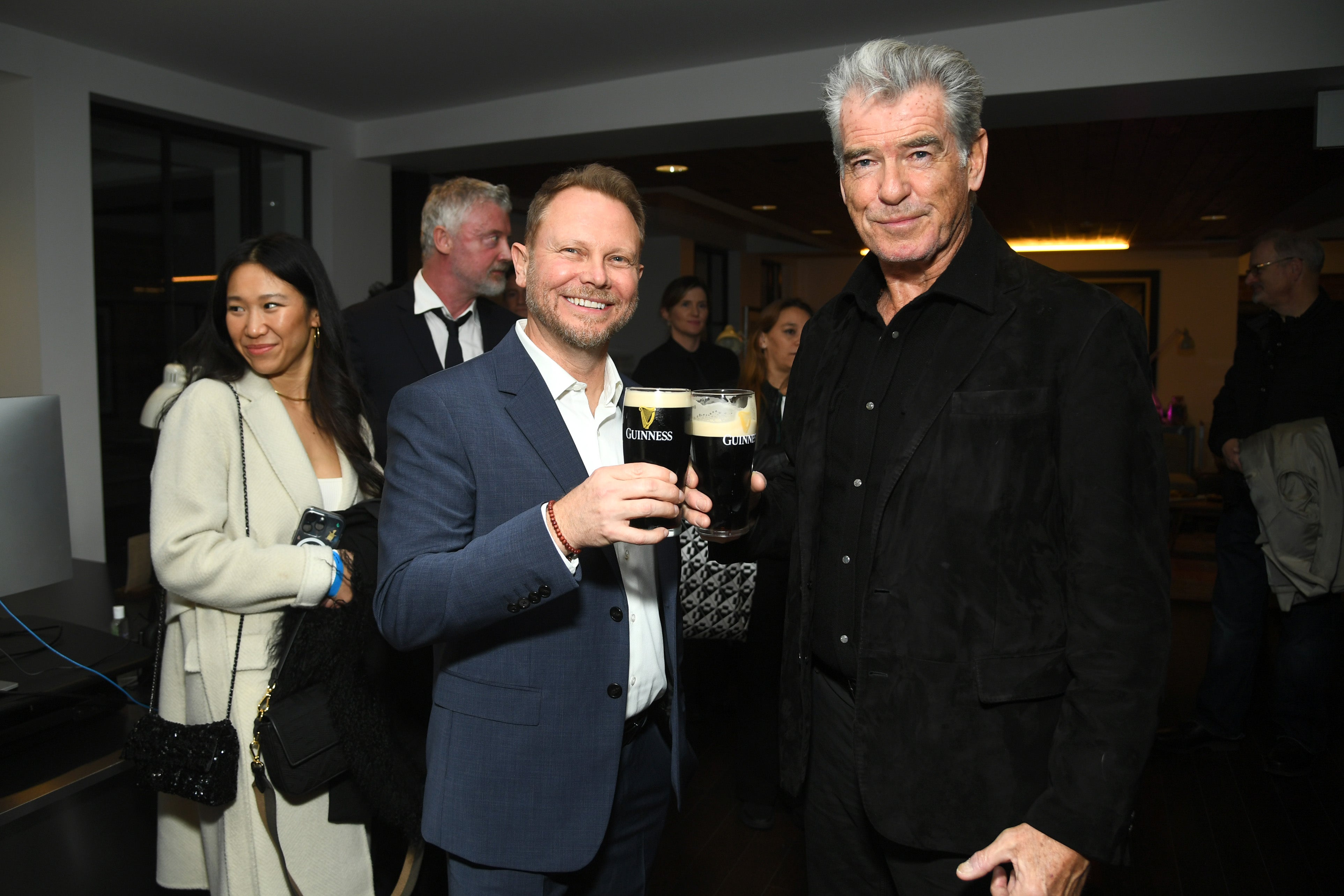 Two-time Oscar winner and Dublin-born animator Richard Baneham, whose Oscar Wilde Award was presented on Thursday by James Cameron, raises a pint of Guinness next to his fellow honouree, Irish actor Pierce Brosnan