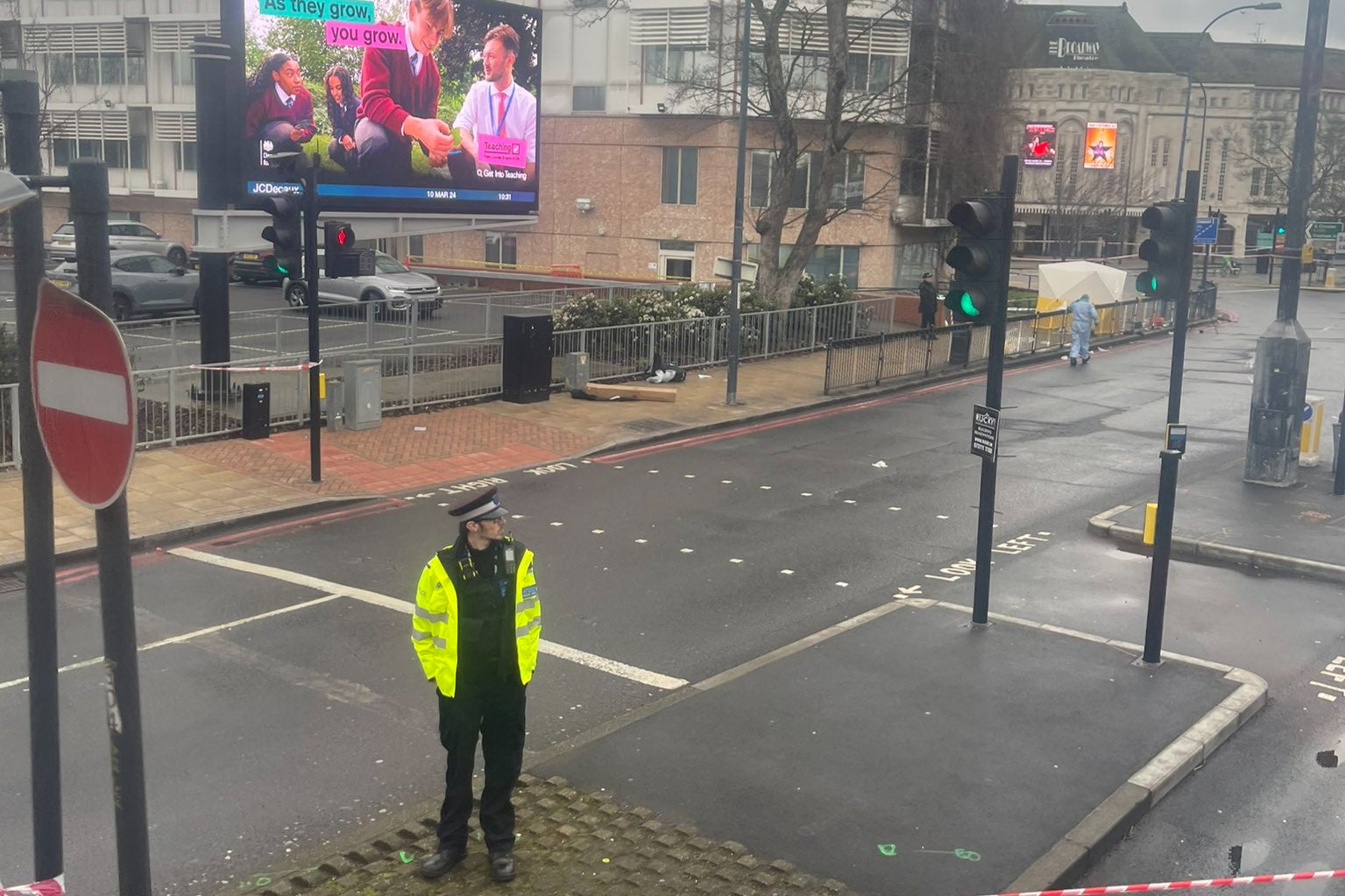 A police officer guards a taped off area following the shooting in Catford Broadway