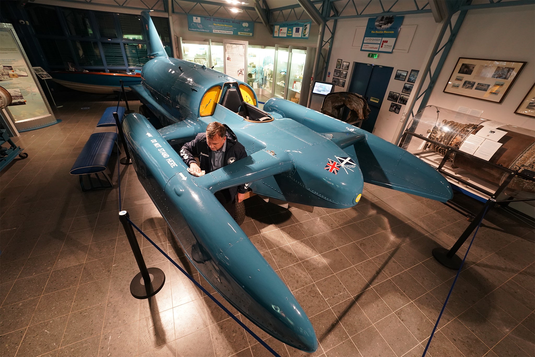 Phil Johnston puts the finishing touches to record-breaking hydroplane boat, Bluebird K7 after it was placed in the Ruskin Museum on it return to Coniston Water in the Lake District