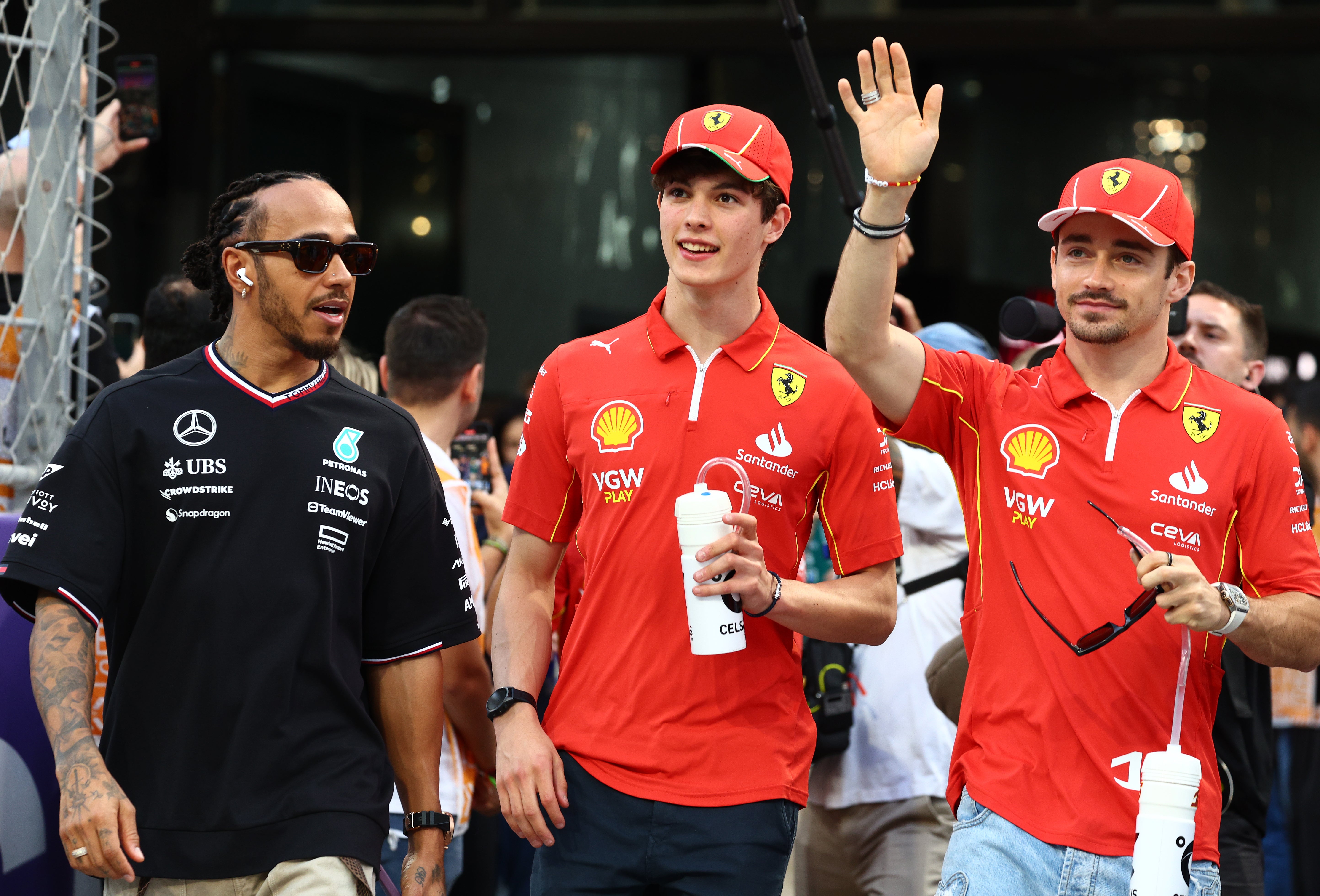 Bearman on his way to his first drivers’ parade with Lewis Hamilton and Charles Leclerc