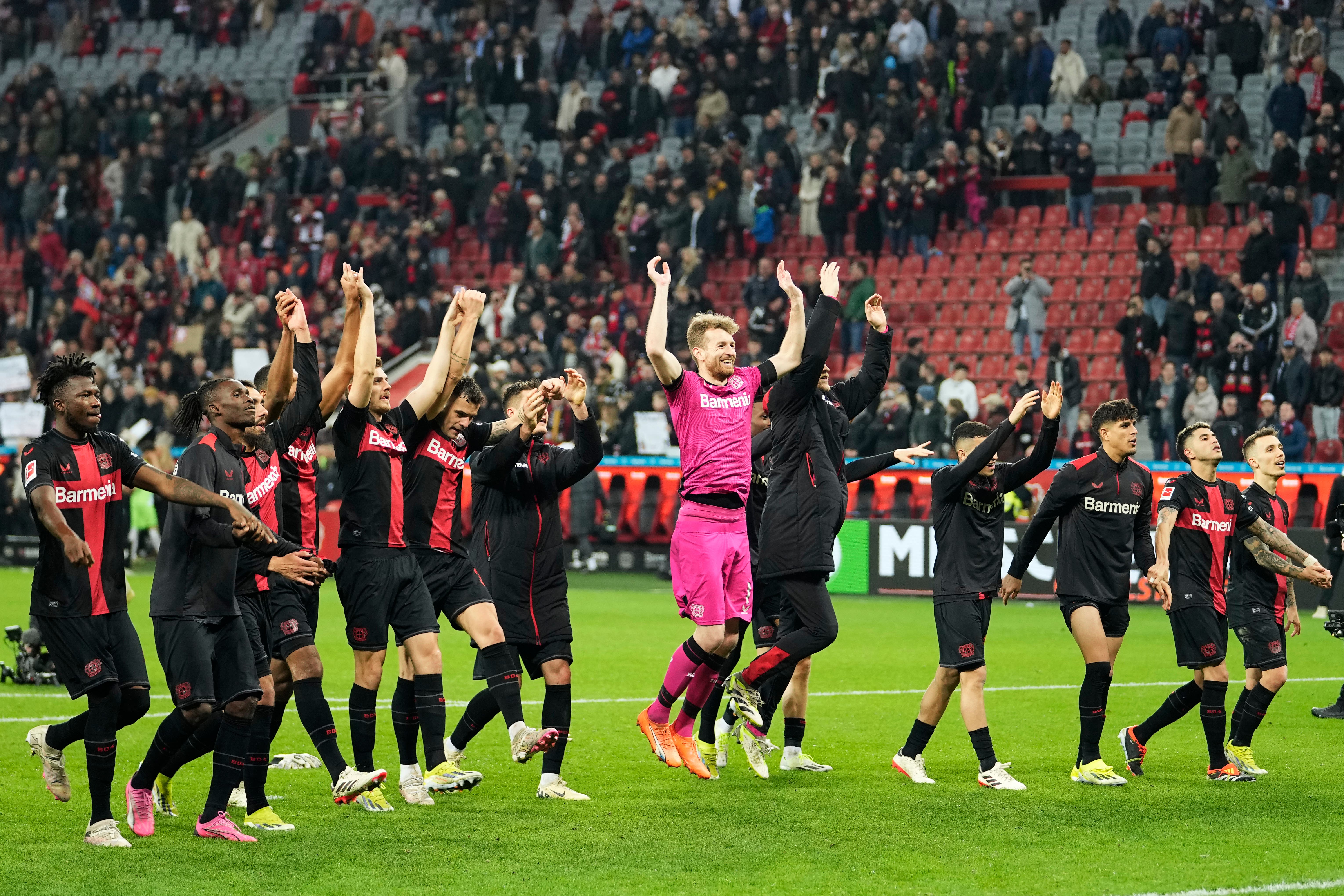 Bayer Leverkusen celebrate Sunday’s victory over Wolfsburg which moved them 10 points clear at the top of the Bundesliga table (Martin Meissner/AP)