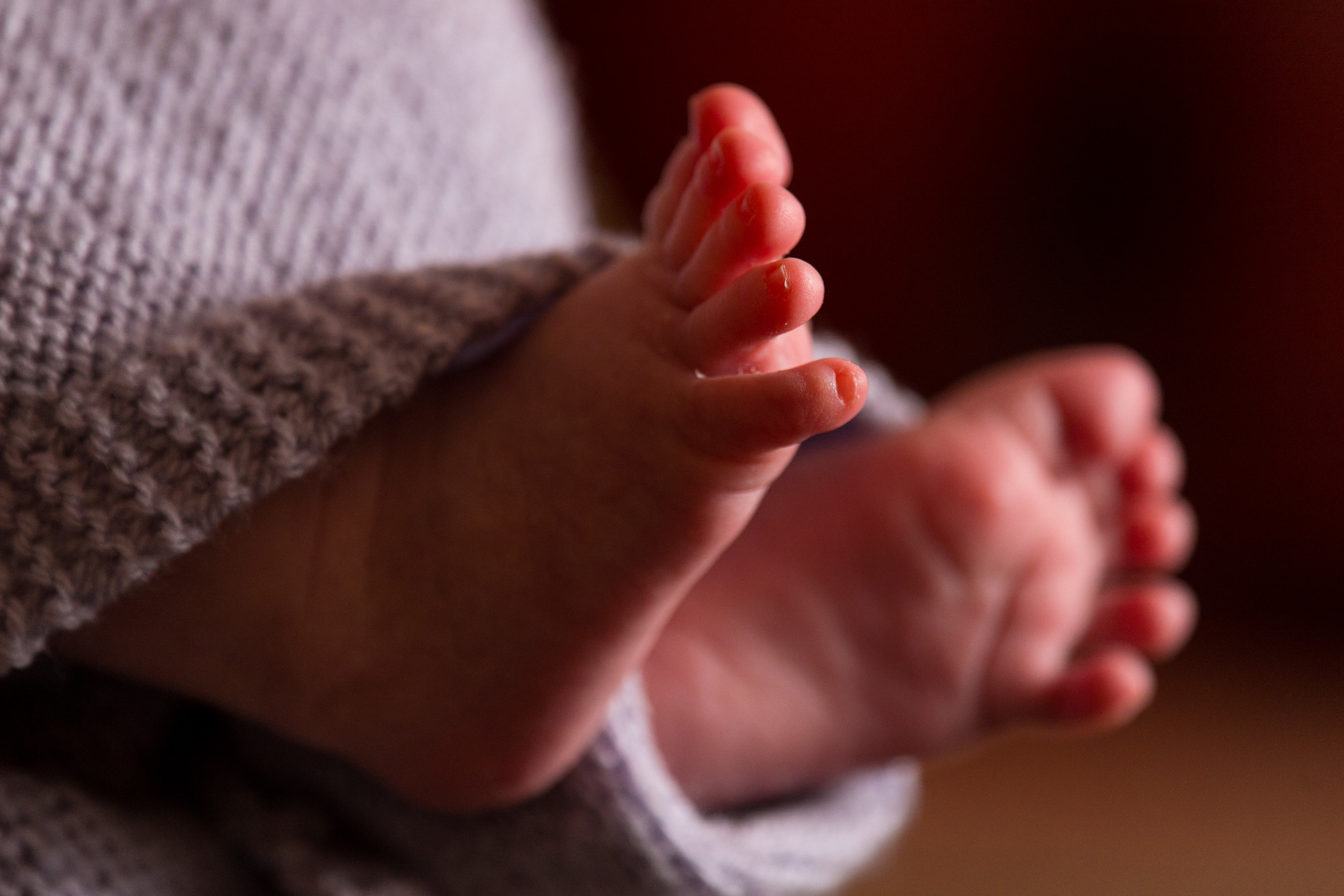 The Lullaby Trust recommends babies are placed down to sleep on their backs on a firm, flat surface, with no loose bedding or padding (Dominic Lipinski/PA)