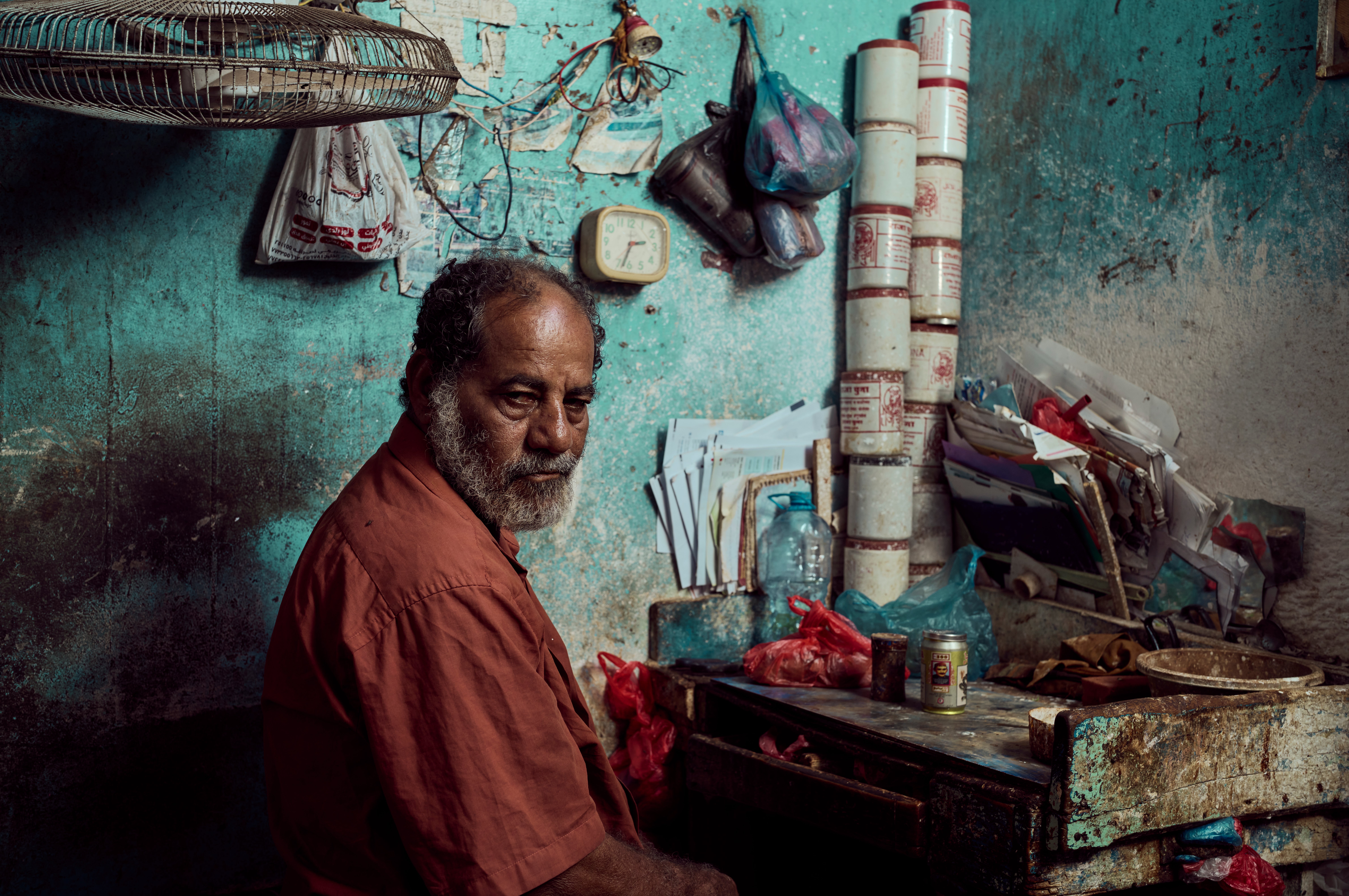 Salam prepares betel nut for customers in his two-room dwelling which is home to 22 members of his extended family near the fishing port of Sirah