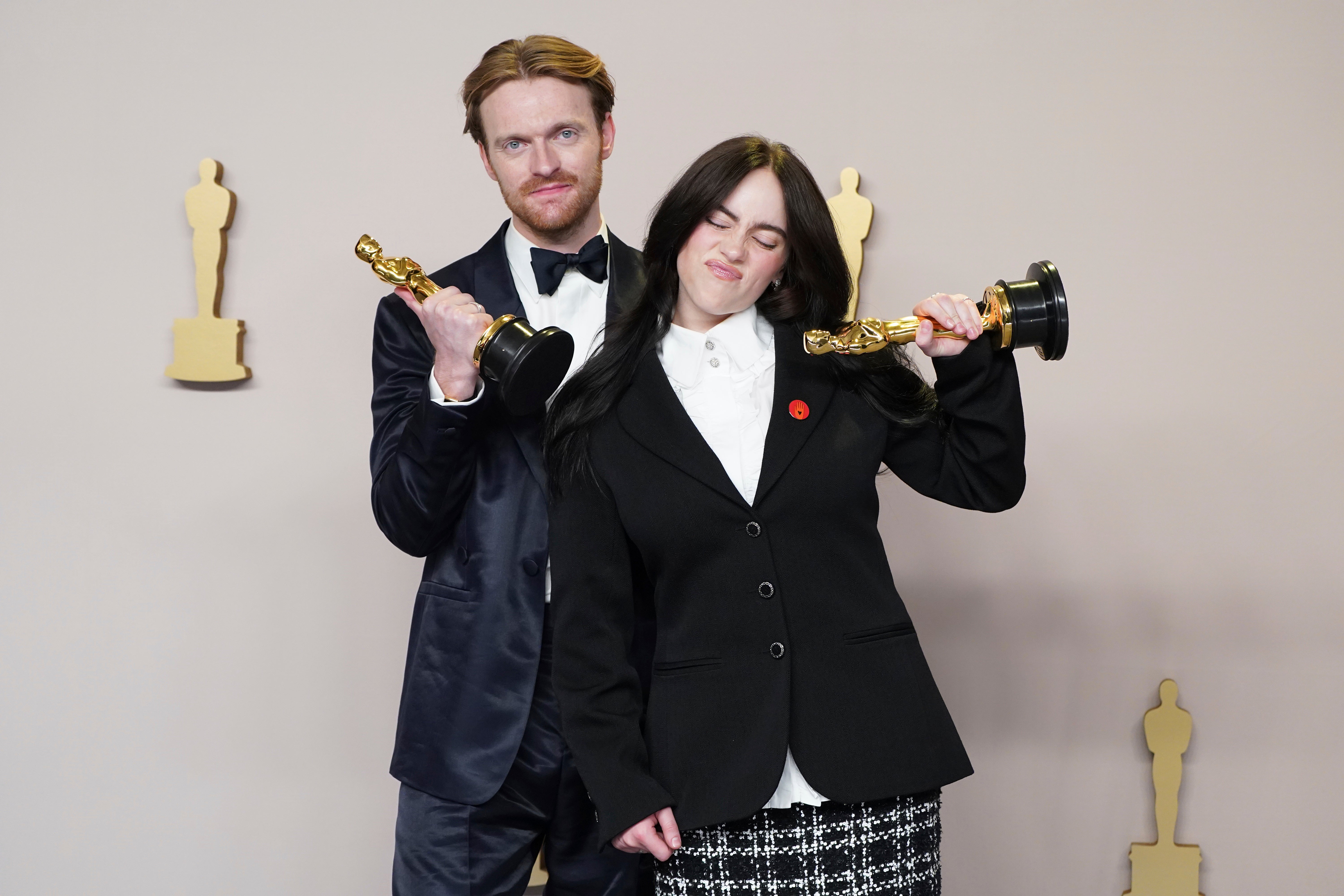 Finneas and Billie Eilish with their Oscar trophies for Best Original Song