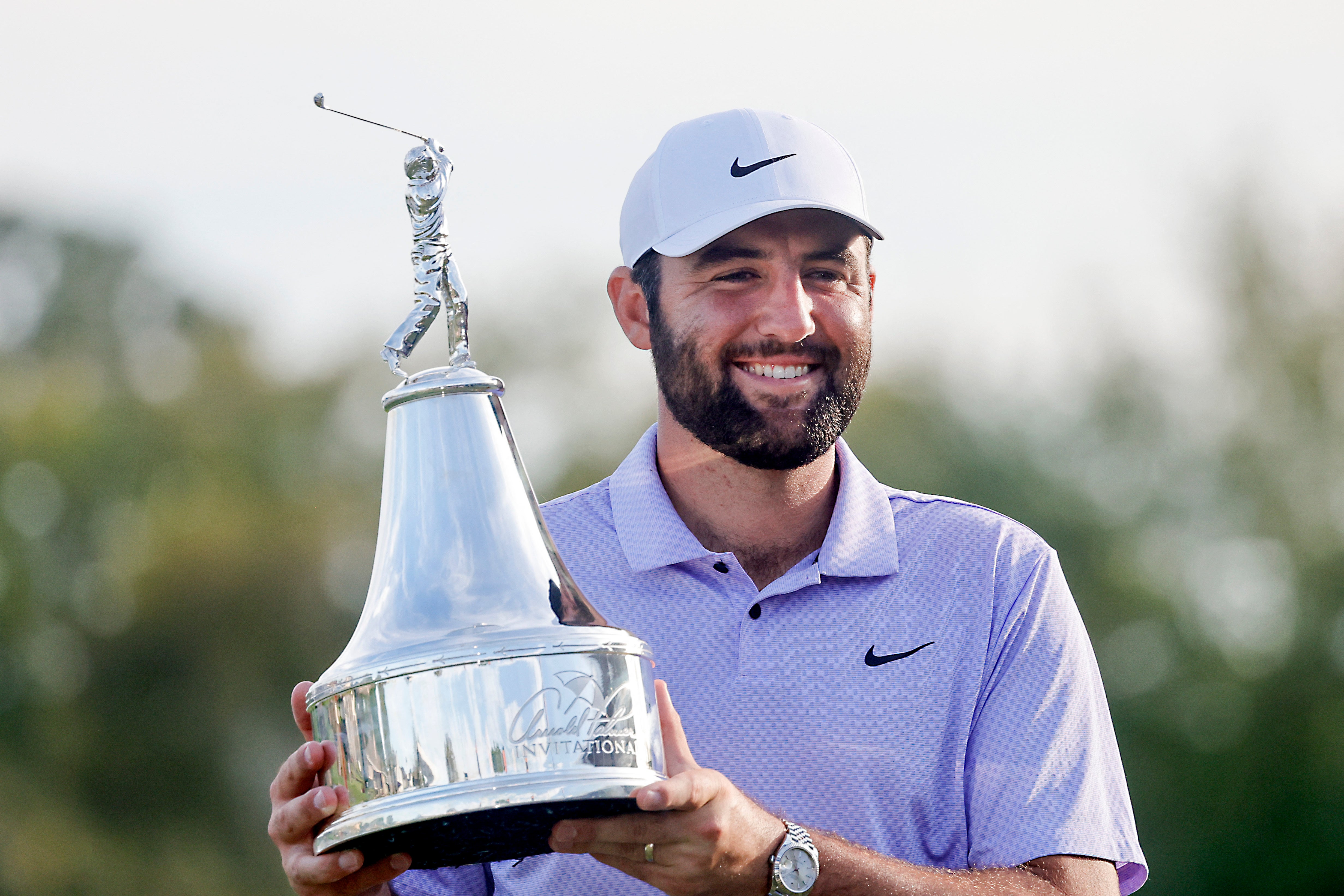 Scottie Scheffler holds the champions trophy after winning the Arnold Palmer Invitational golf tournament