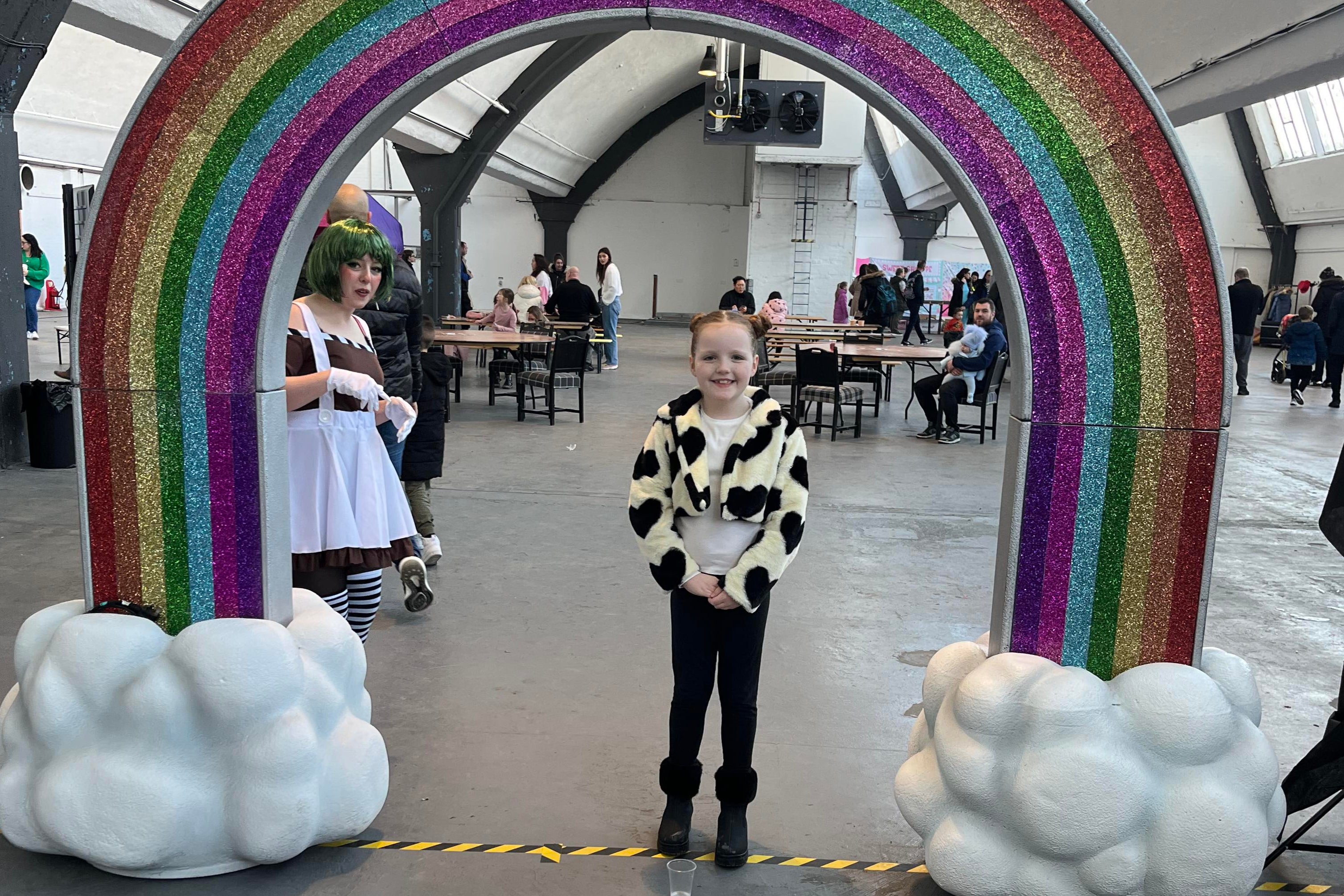 Maryanne Mccormack’s daughter Perri smiling under the makeshift rainbow and next to the hardworking Oompa Loompa