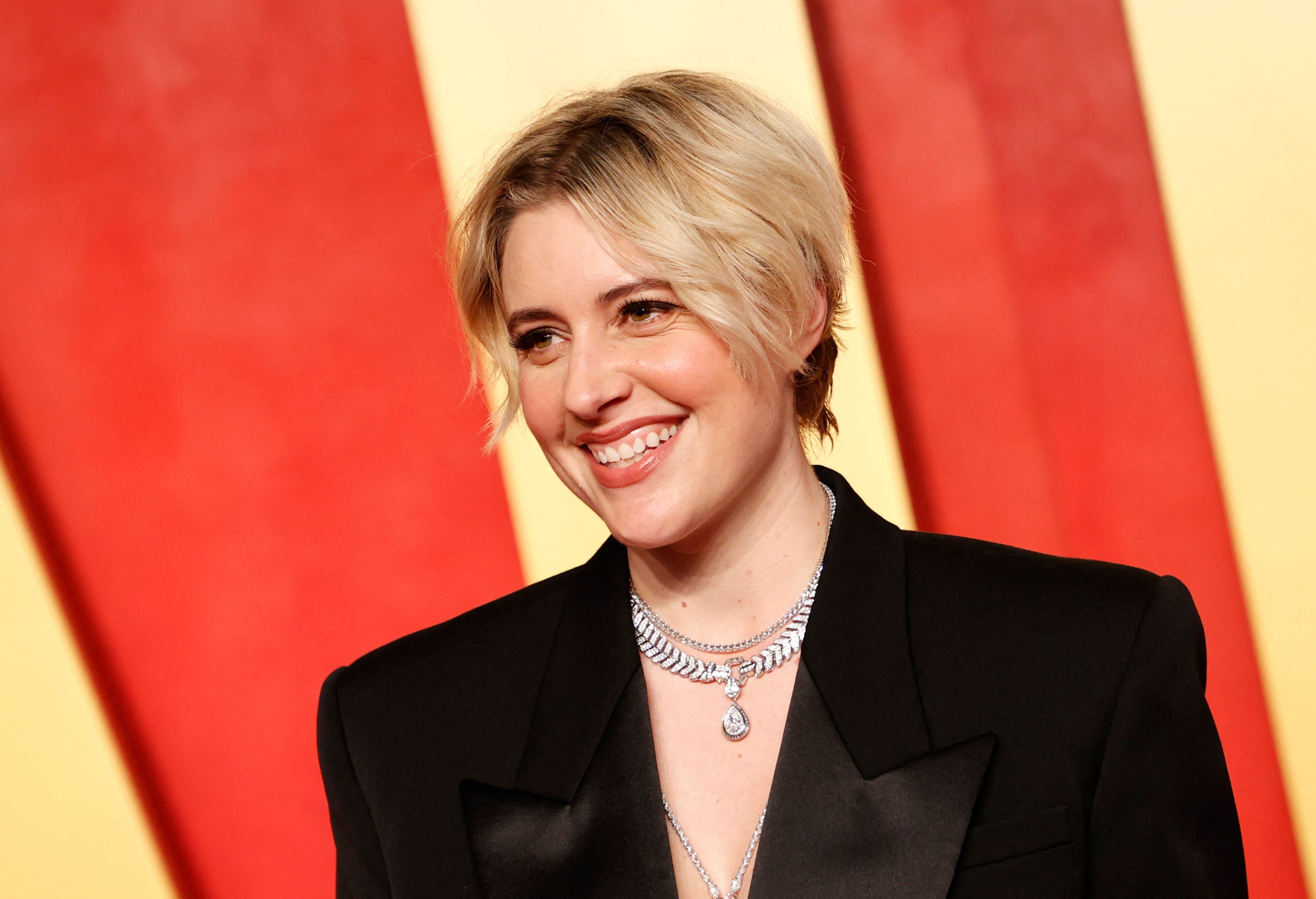 Greta Gerwig posing on the red carpet at the Vanity Fair Oscar party