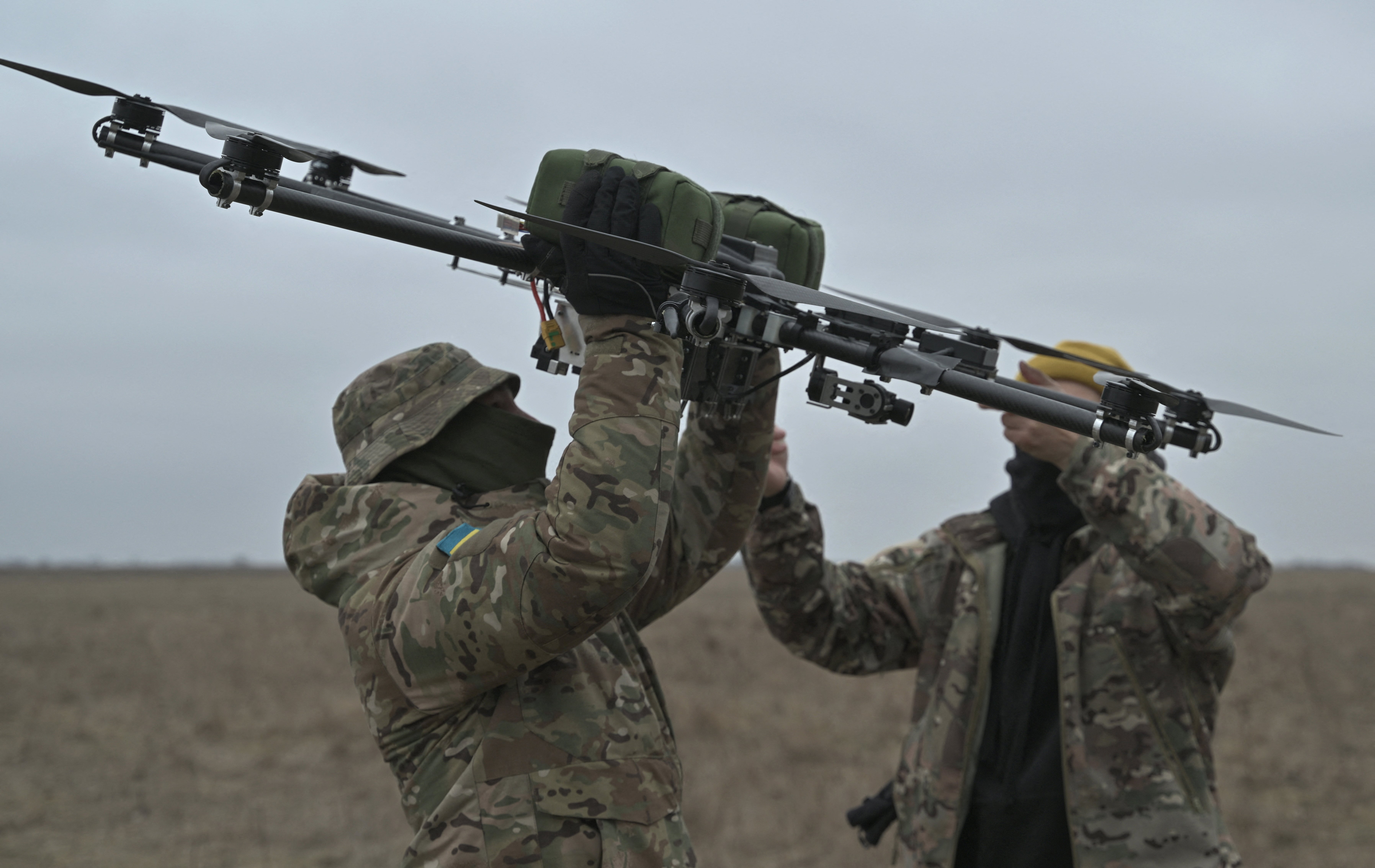 Pilots carry a drone on a training ground in Kyiv region on February 23