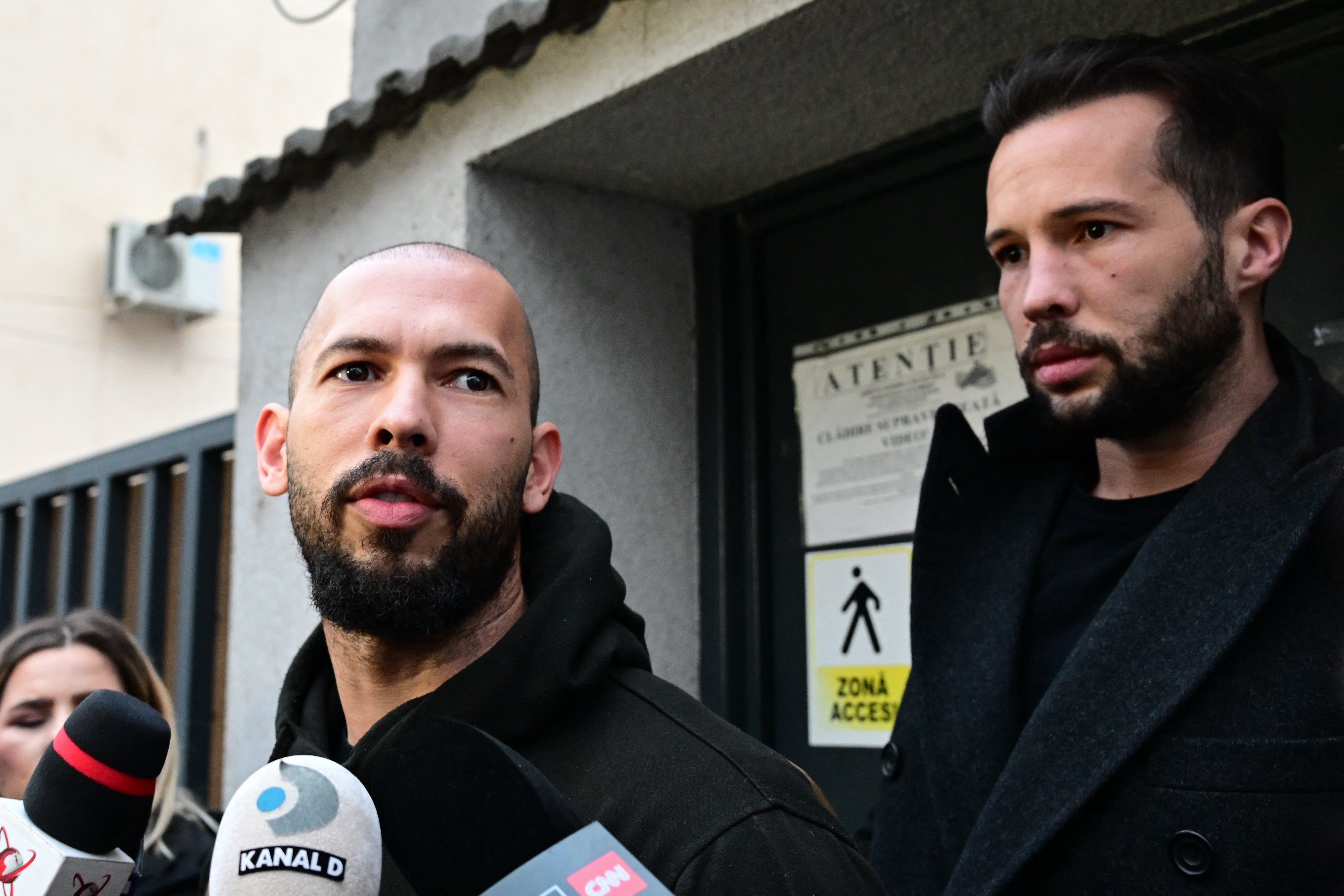 Andrew Tate and his brother leaving Bucharest Court of Appeal