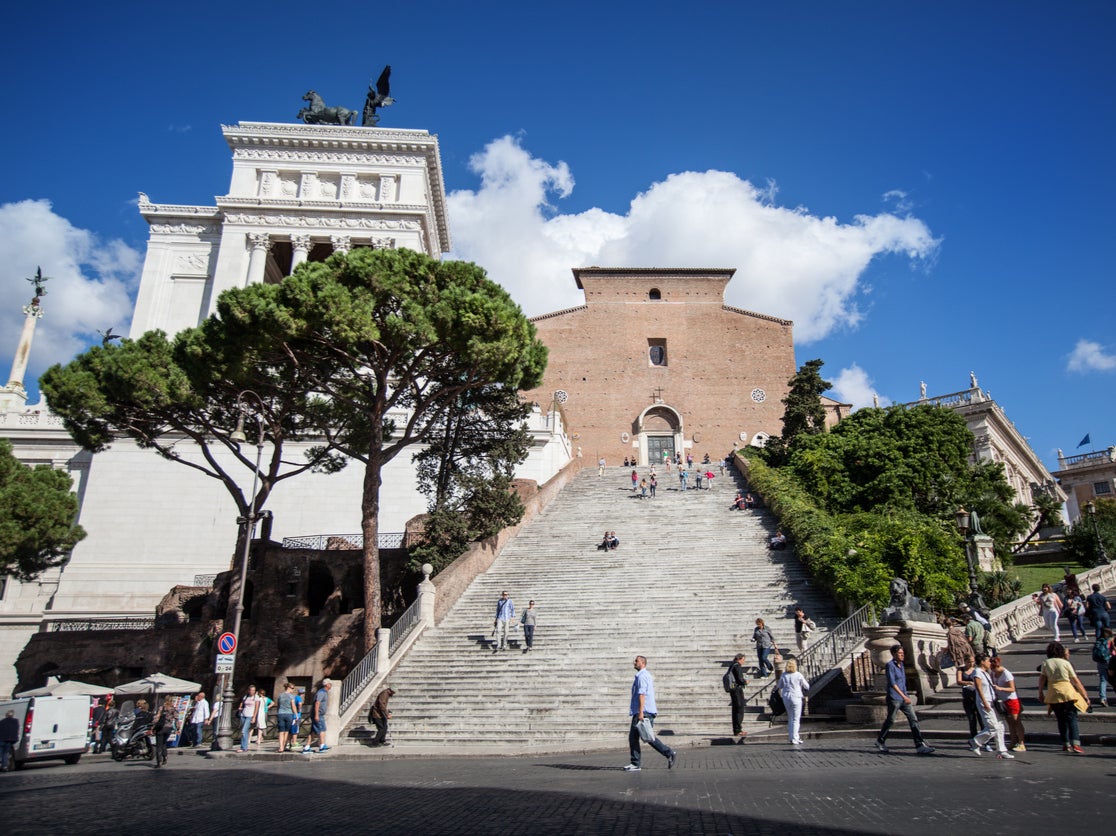 The ruins of a Roman apartment block go unnoticed in the shadow of Rome’s Il Vittoriano and Santa Maria Aracoeli