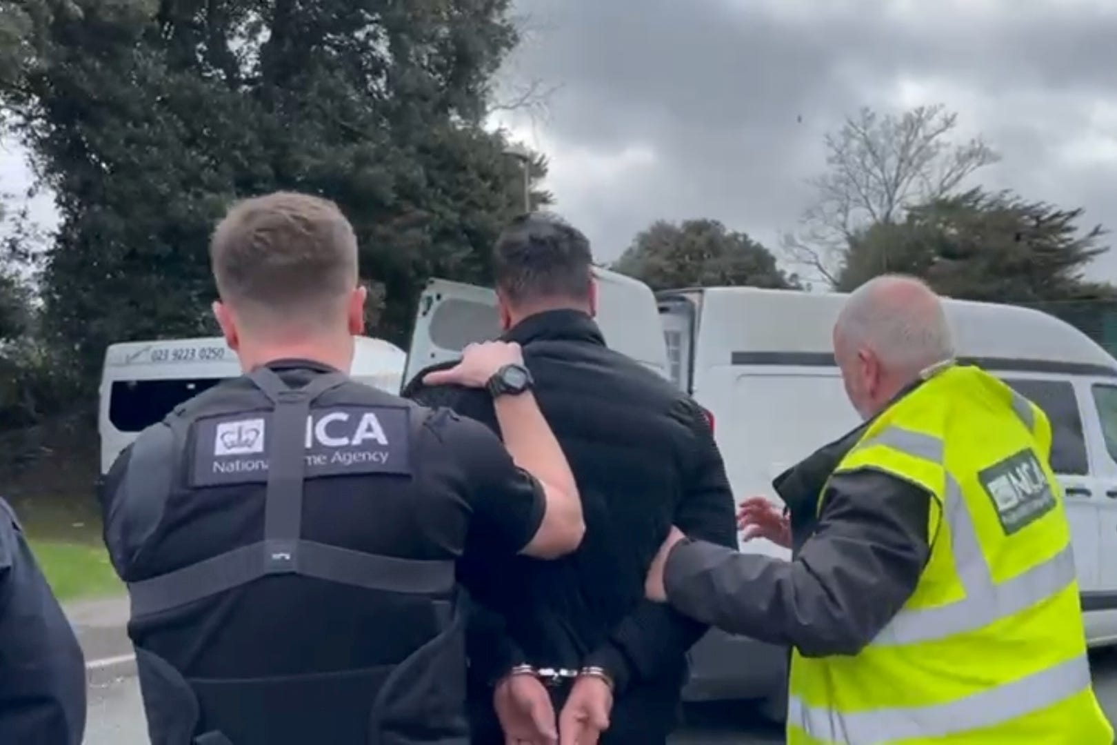 National Crime Agency officers arrest a man in Portsmouth on suspicion of people smuggling (NCA/PA)