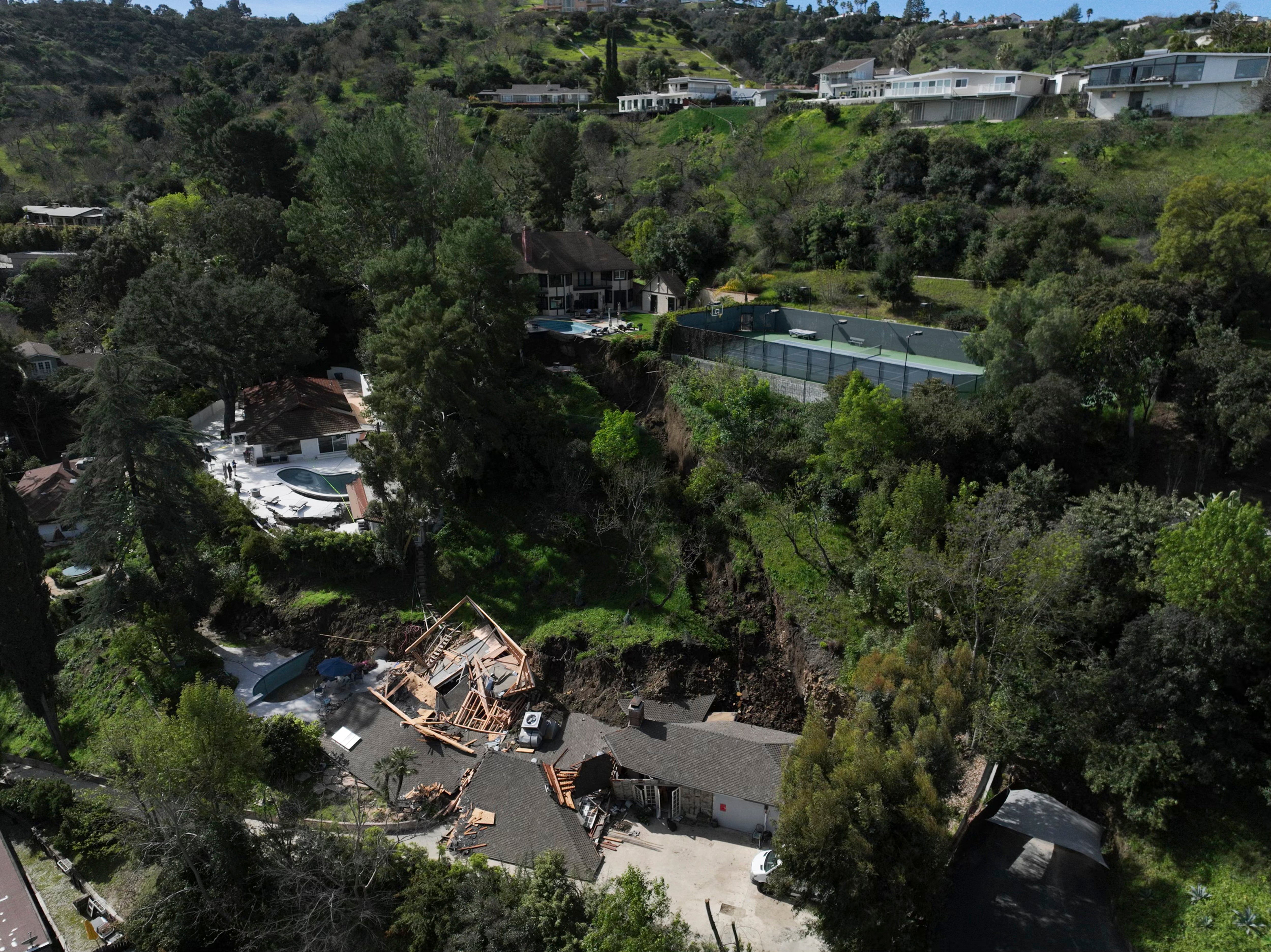 The LAFD responded to reports of a large tree down and wires down in the backyard of a residence in the early hours of Wednesday