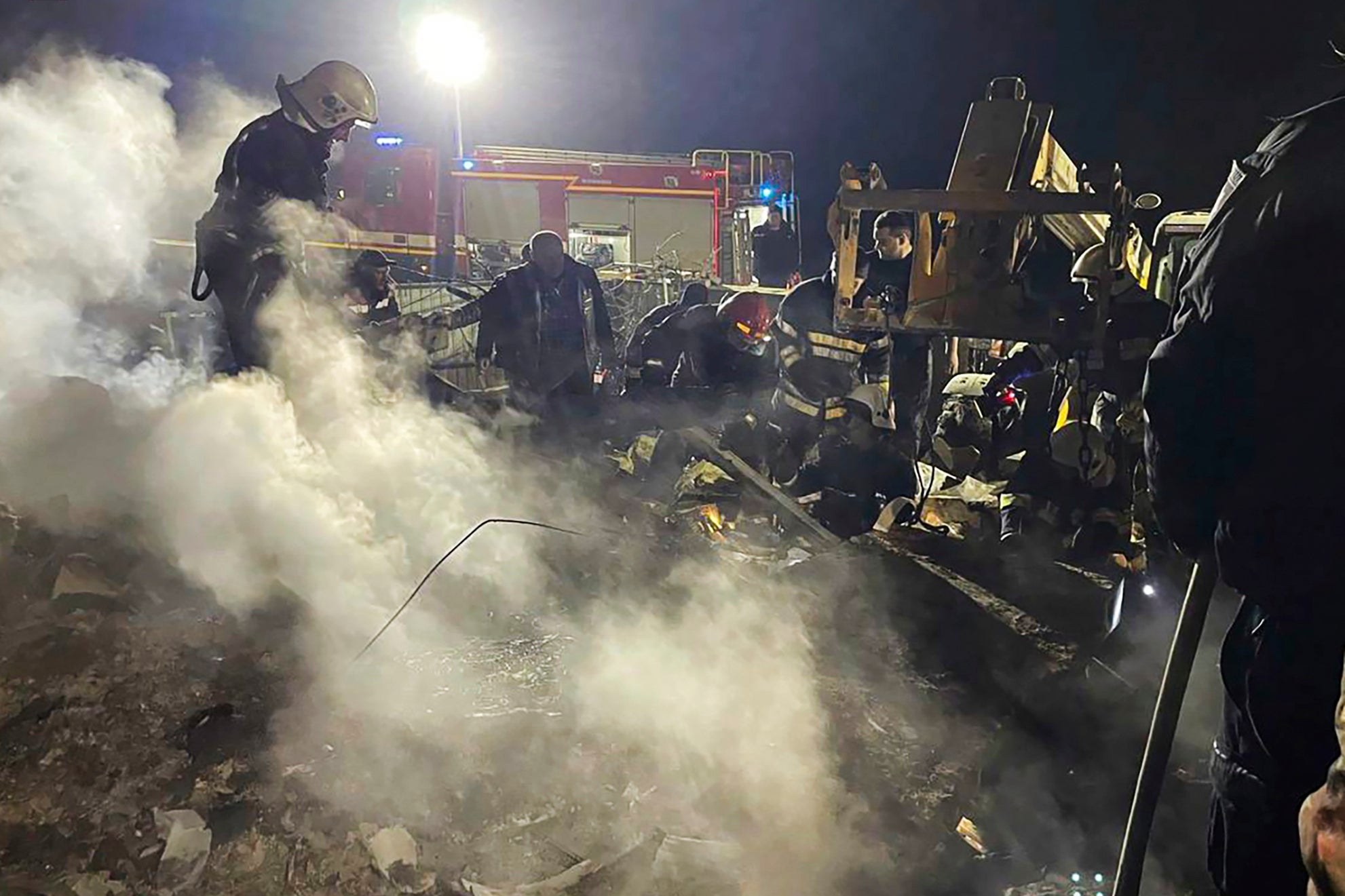 Emergency services work at the scene of a building that was damaged by a Russian drone attack in Vinnytsia, Ukraine