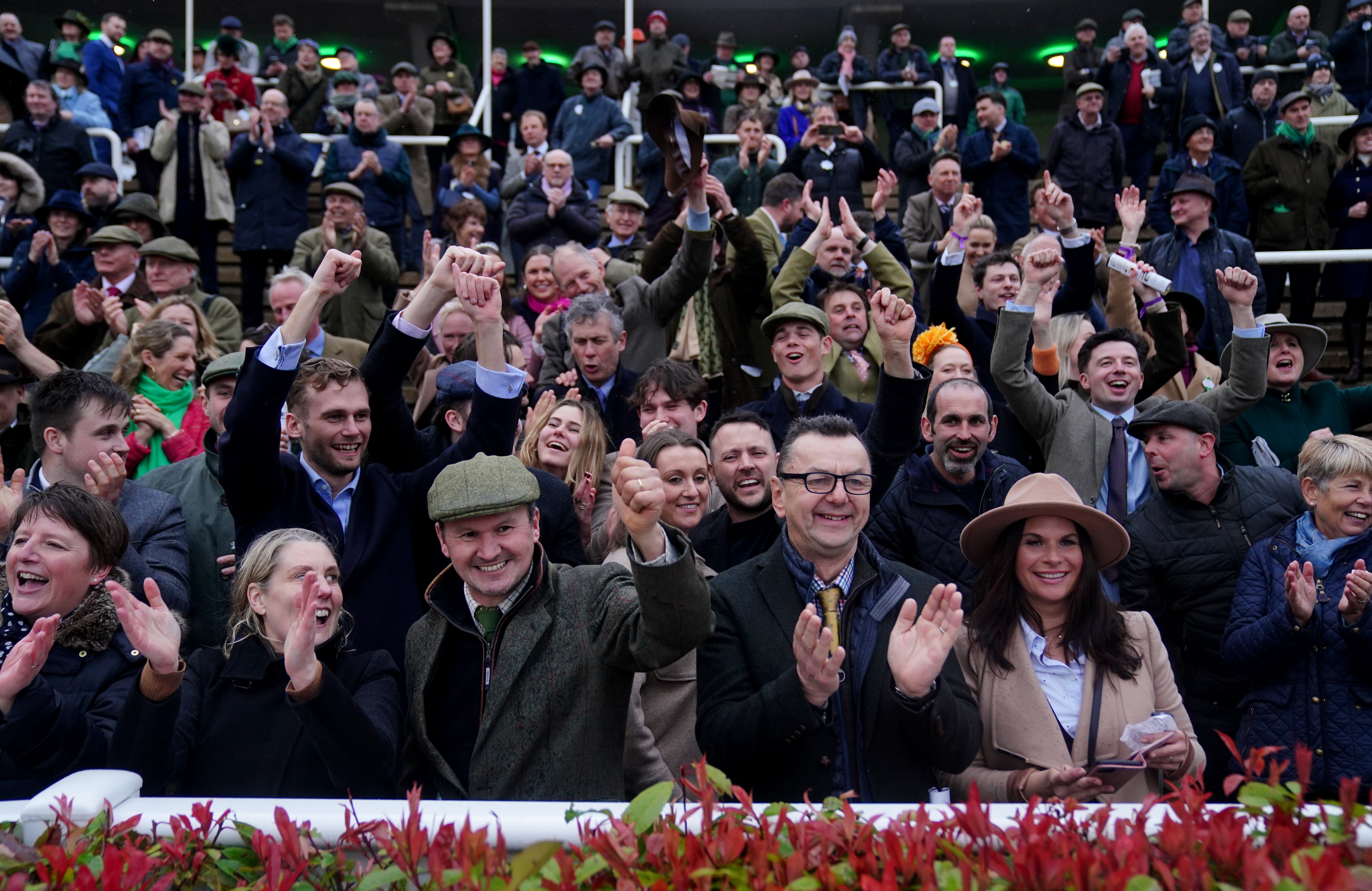 Crowds enjoy watching a race during day three of the Cheltenham Festival, when attendance was down several thousand on last year