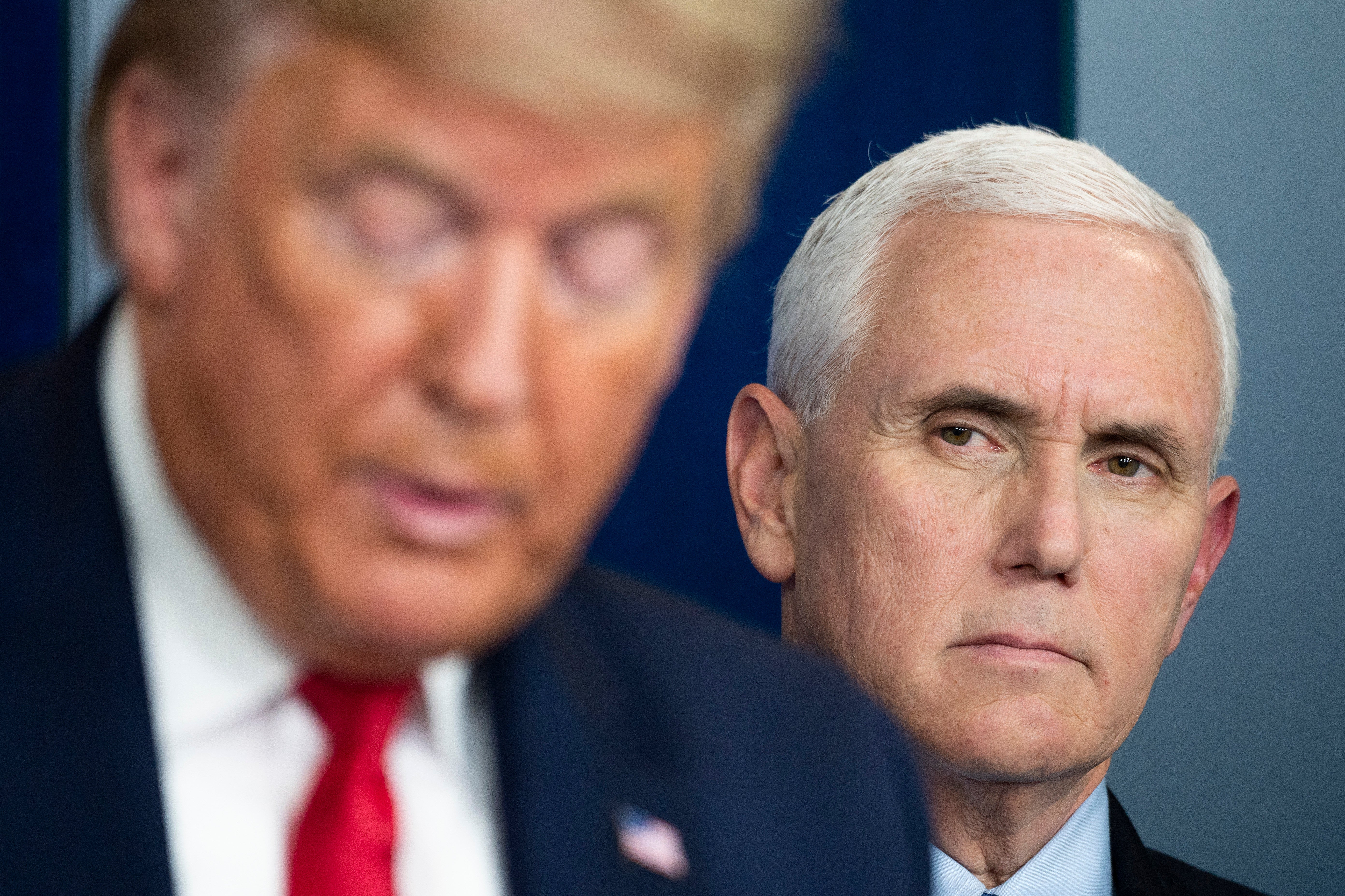 Vice President Mike Pence listens as President Donald Trump speaks during a press briefing at the White House on 26 March 2020. Trump reportedly replied ‘so what’ when he learned Pence was in potential danger during the Capitol riot in 2021