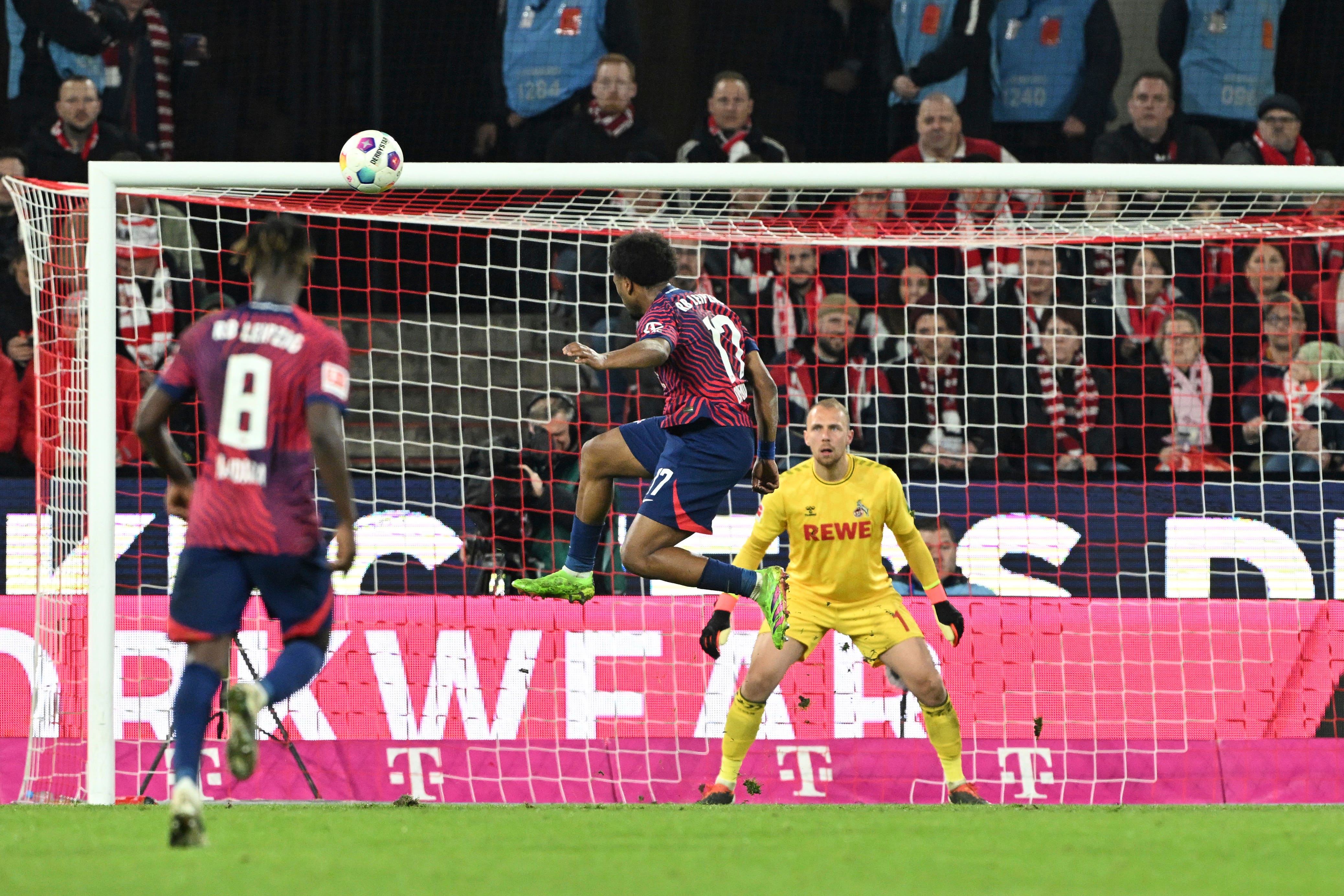 Leipzig’s Lois Openda, center, scores during their 5-1 win over Cologne (Federico Gambarini/AP)