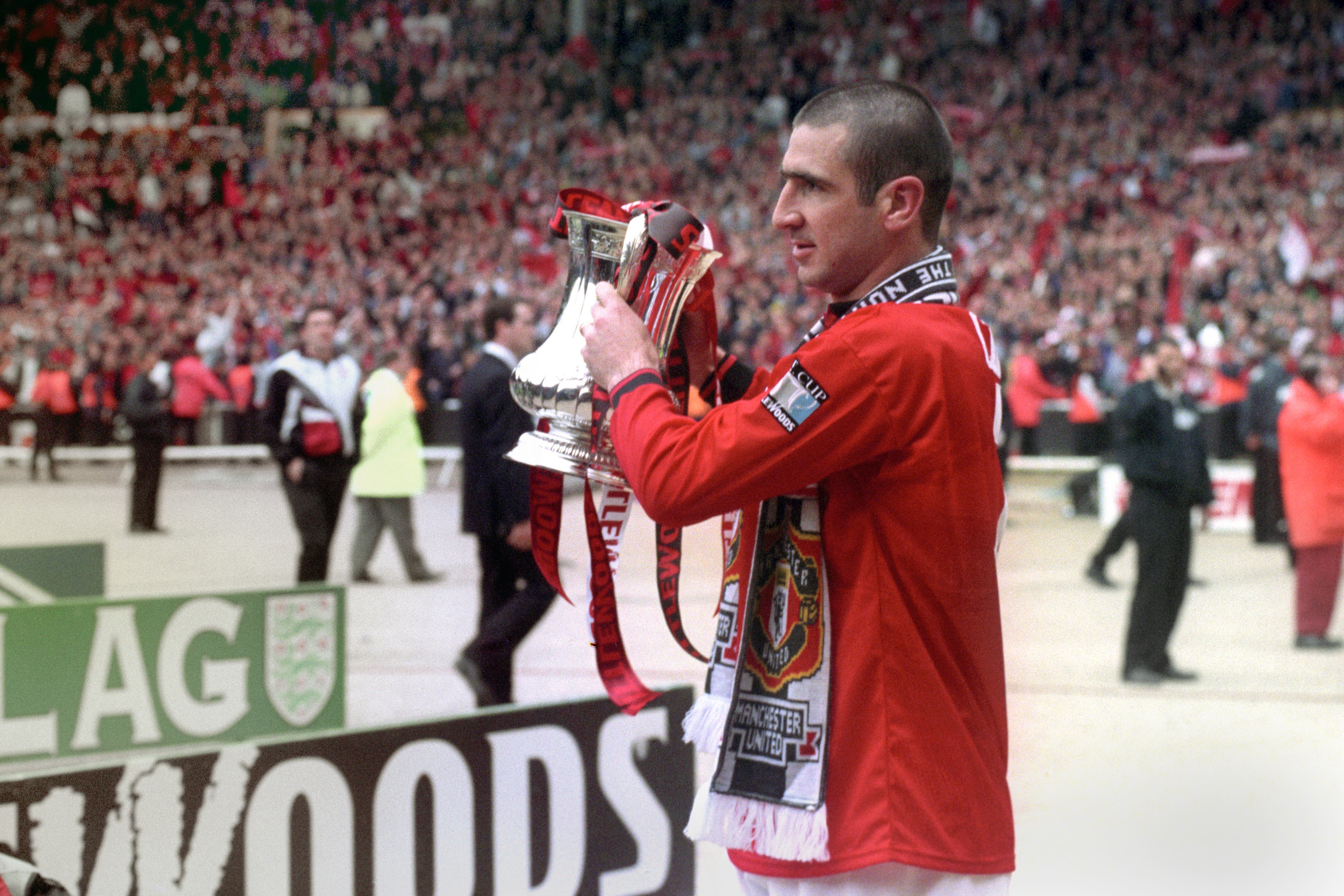 Eric Cantona, lifting the FA Cup, won the competition twice and four Premier League titles with United (PA)