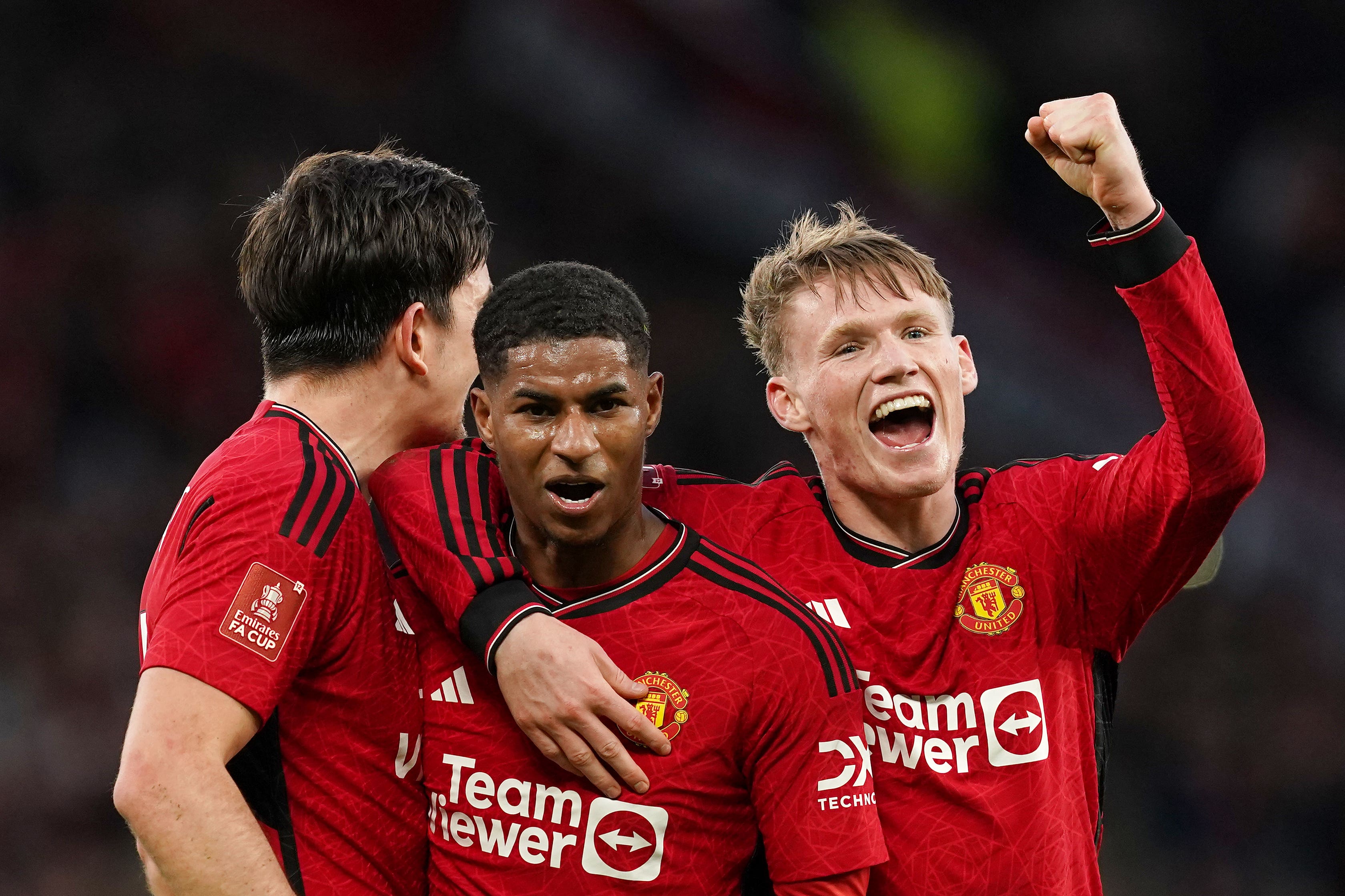 Manchester United’s Marcus Rashford (centre) and team-mates Scott McTominay and Harry Maguire (left) celebrate after beating Liverpool in the FA Cup quarter-final. (Martin Rickett/PA)