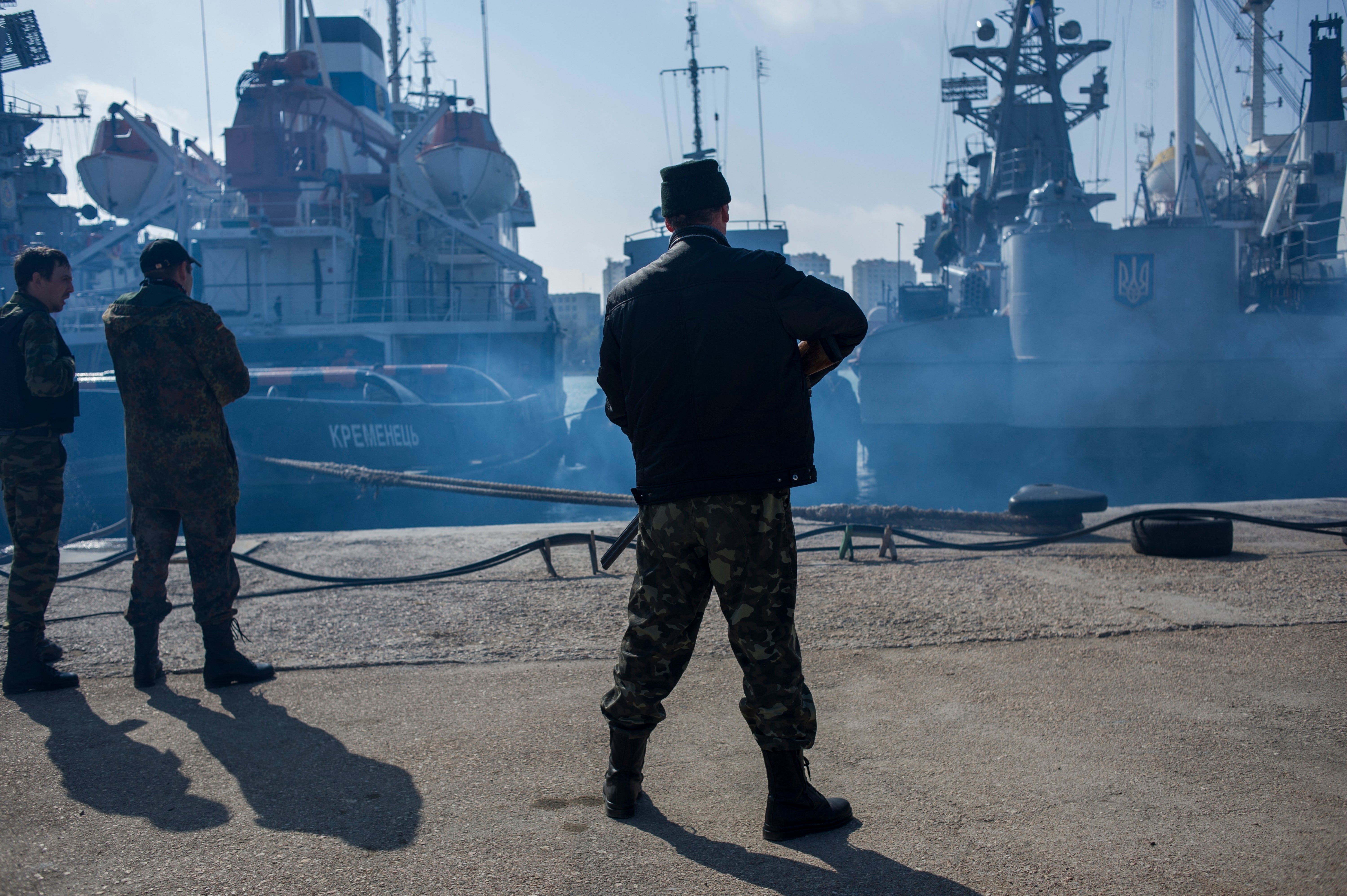 Men in unmarked uniforms stand guard during the seizure of the Ukrainian corvette Khmelnitsky in Sevastopol, Crimea, in March 2014