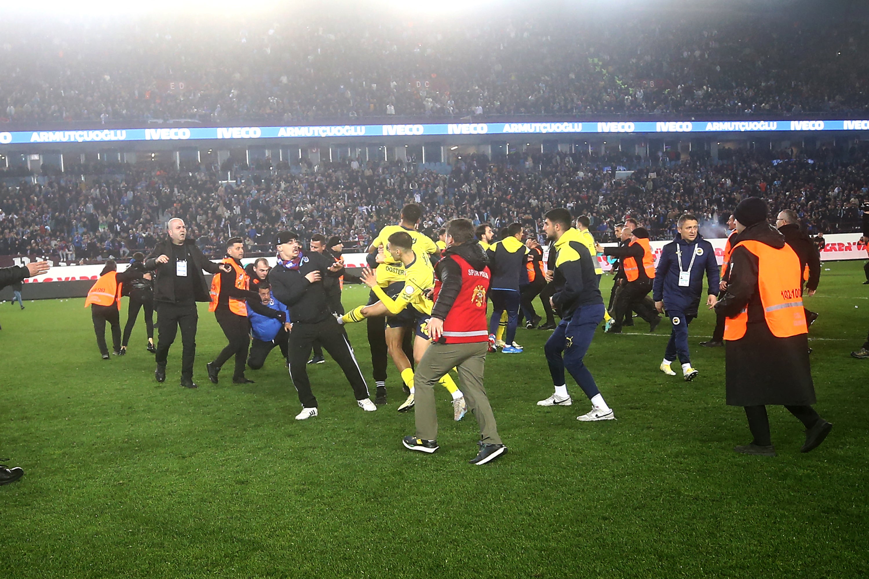 Fenerbahce players try to defend themselves from attack