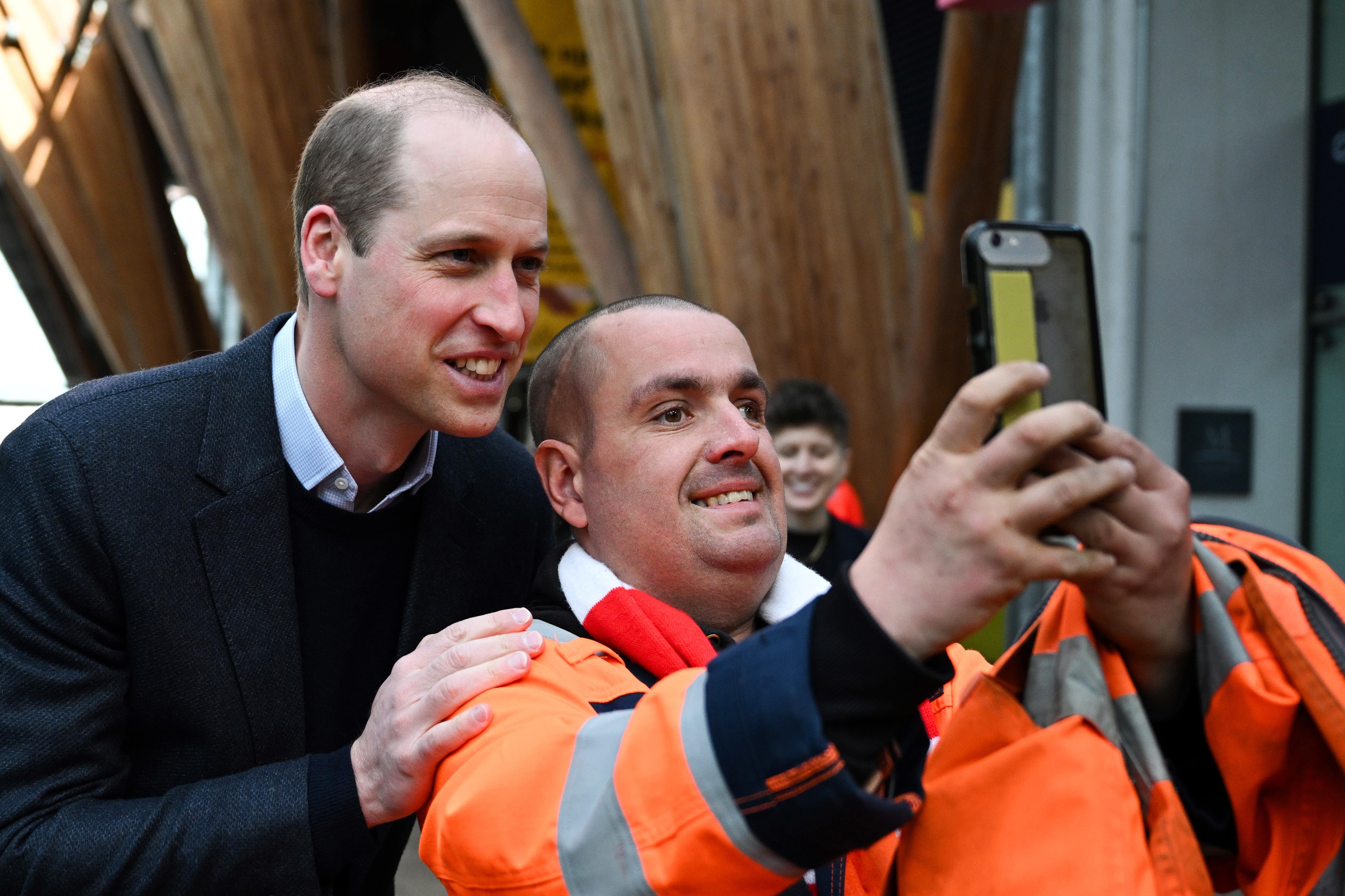 The Prince of Wales poses for pictures with a member of the public on his way to attend a Homewards Sheffield Local Coalition meeting (Oli Scarff/PA)