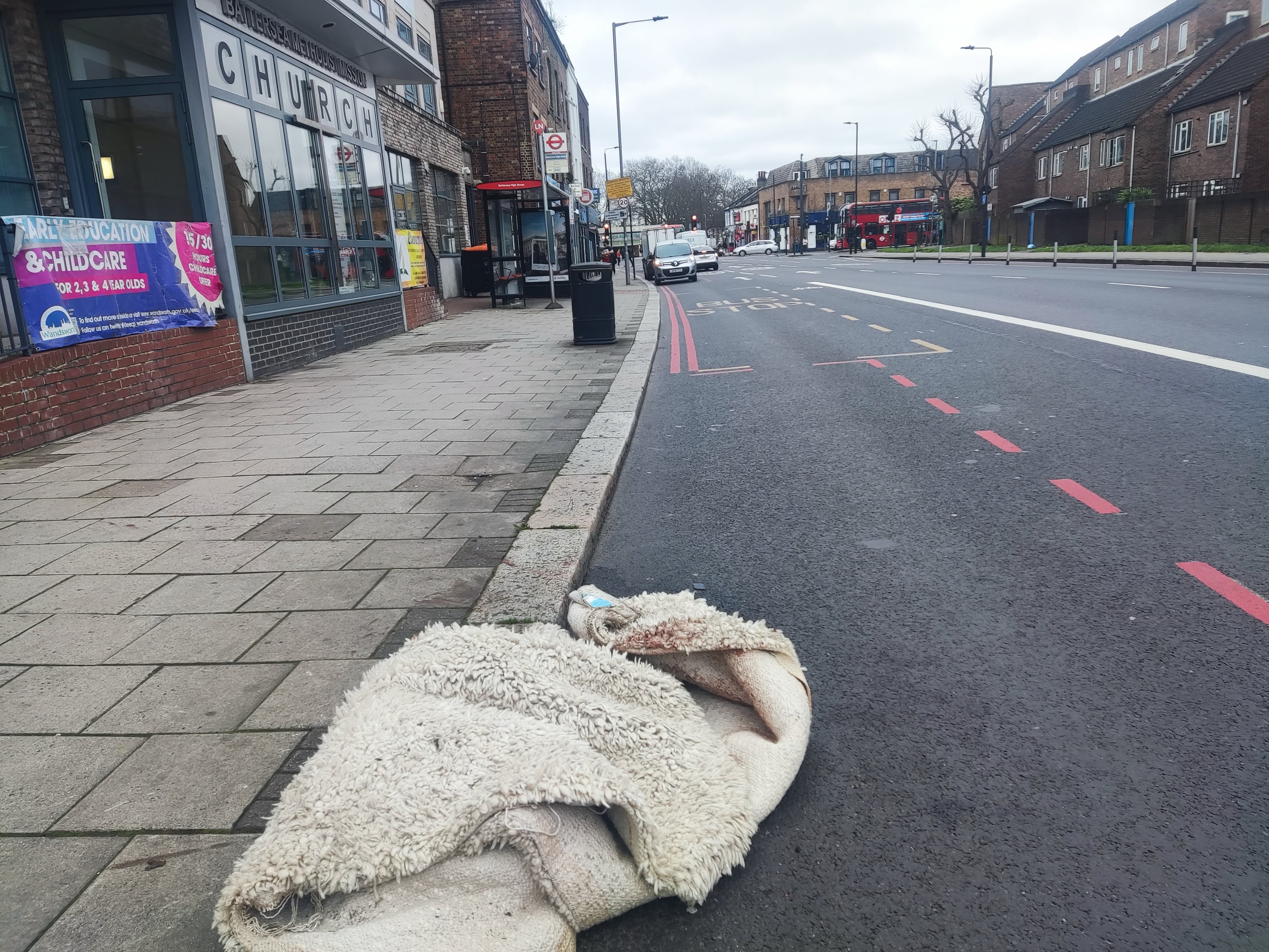 A blood stained blanket, which was used to subdue the dog, lies on a pavement at the scene in York Road, Battersea