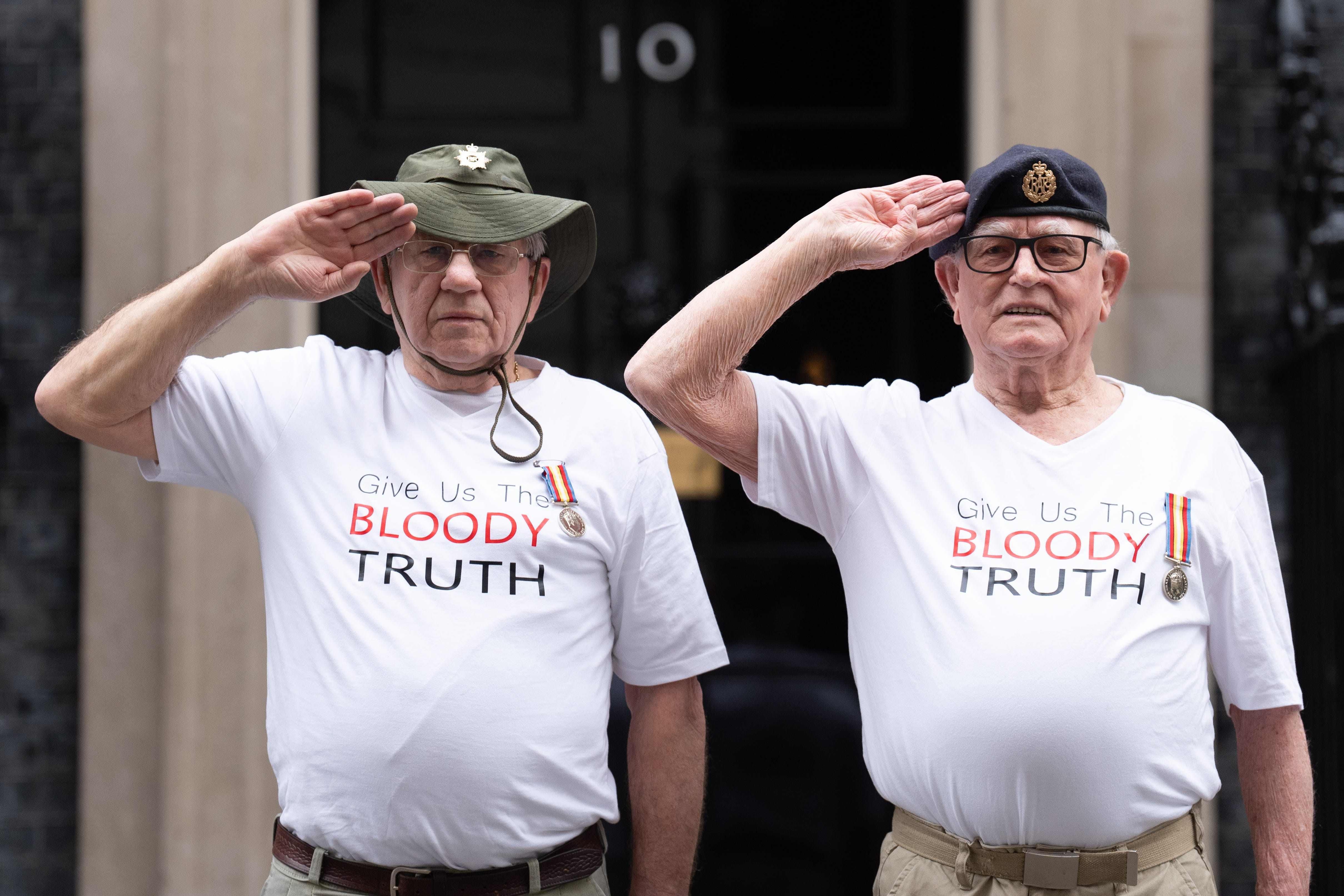 Veterans of Britain’s Cold War radiation experiments Terry Quinlan (left) and Brian Unthank (right) hand a petition in at Downing Street