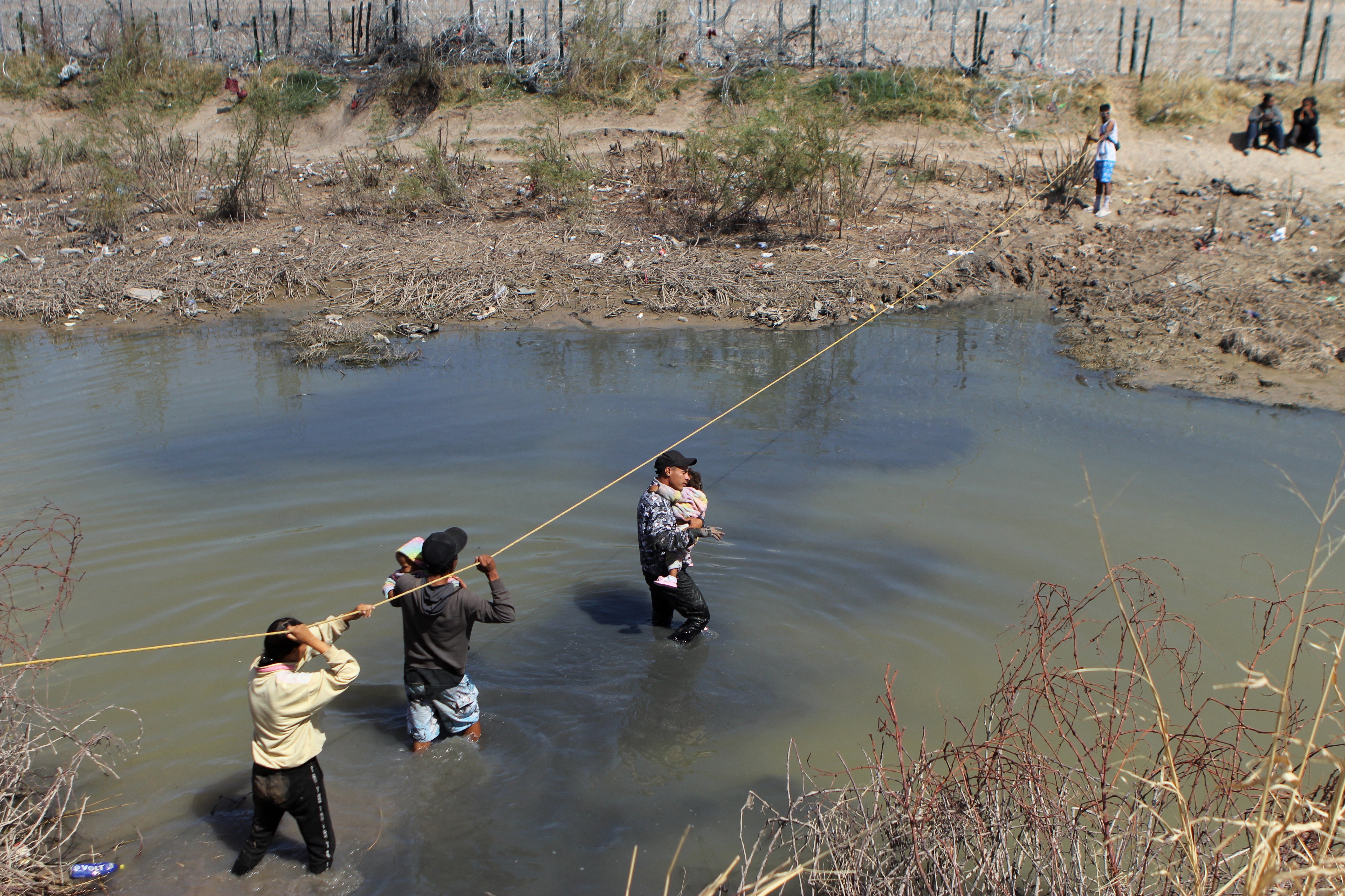 Migrants seeking asylum in the United States cross the Rio Bravo on the border of Ciudad Juarez, Chihuahua state, Mexico on 19 March 2024