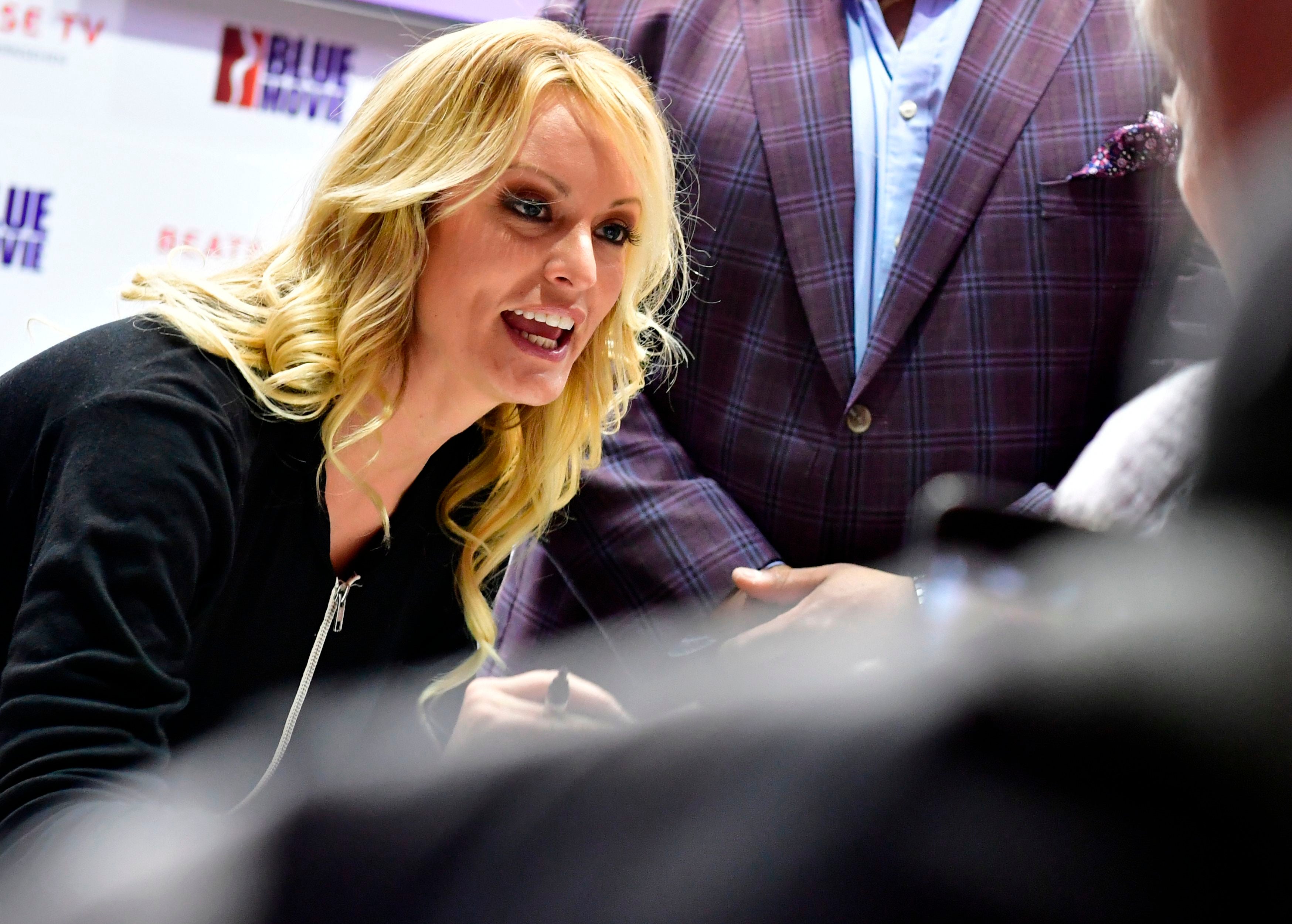 Adult film actress Stormy Daniels signs autographs at the Venus Fair for Erotic Entertainment and Lifestyle on October 12, 2018 in Berlin