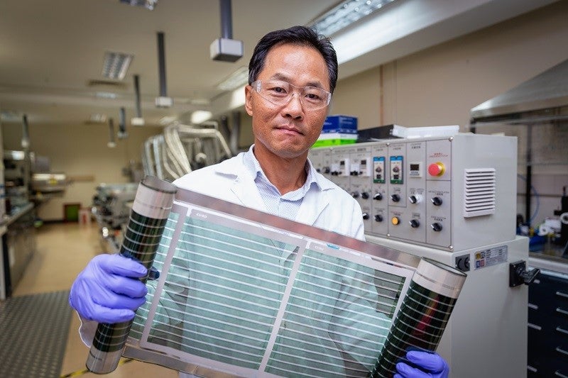 Dr Doojin Vak holds up a roll of flexible printed solar cells that use the ‘miracle material’ perovskite