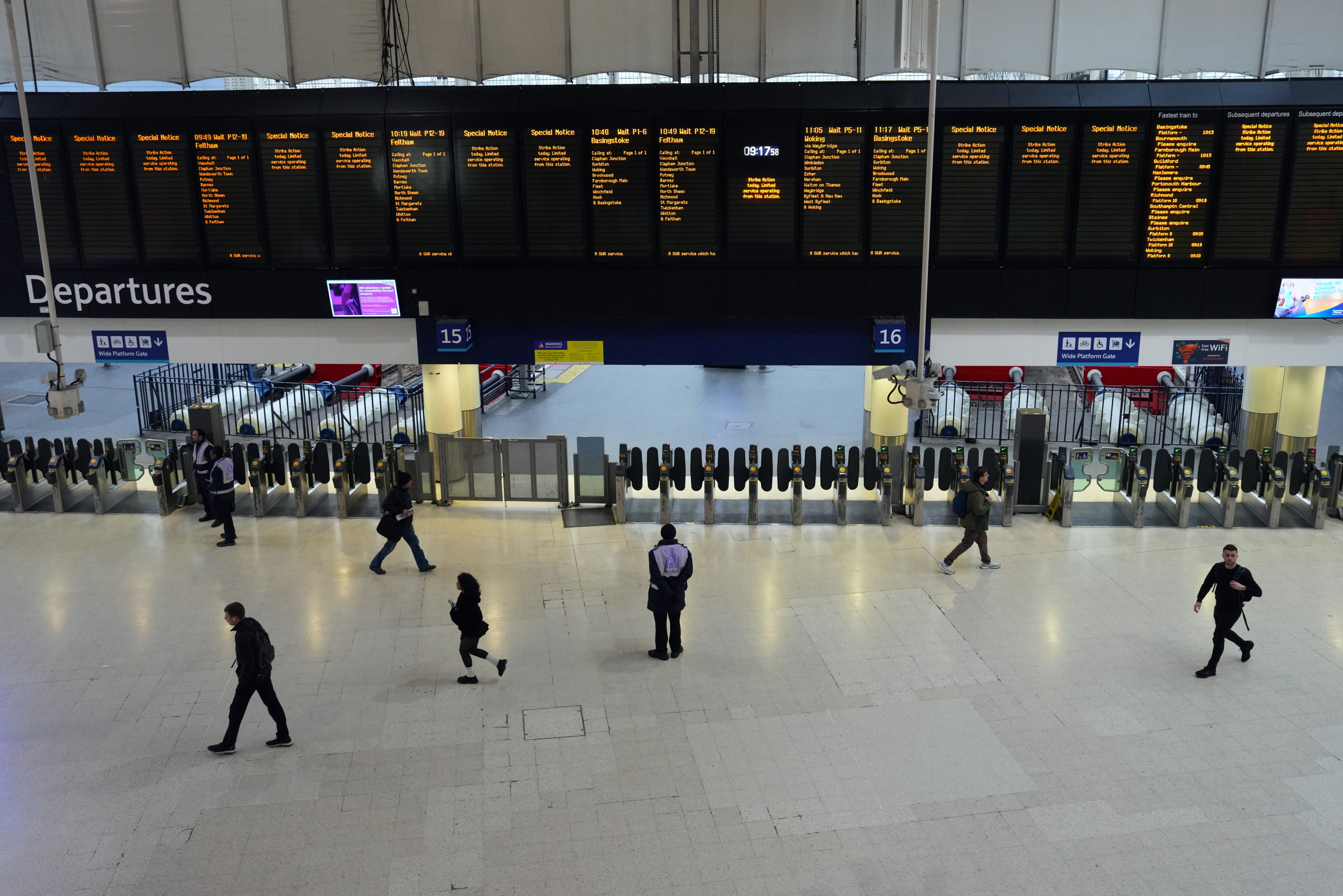 people pass through Waterloo Railway Station during a strike by members of the Associated Society of Locomotive Engineers and Firemen union (ASLEF) on January 30, 2024