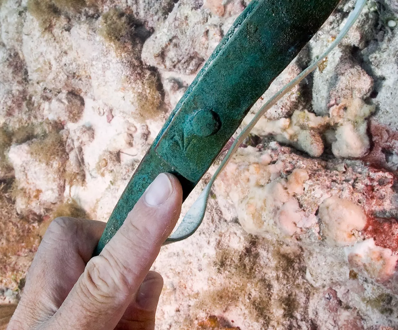 A ‘broad arrow’ marking on a copper barrel band, which showed that it was owned by the British military