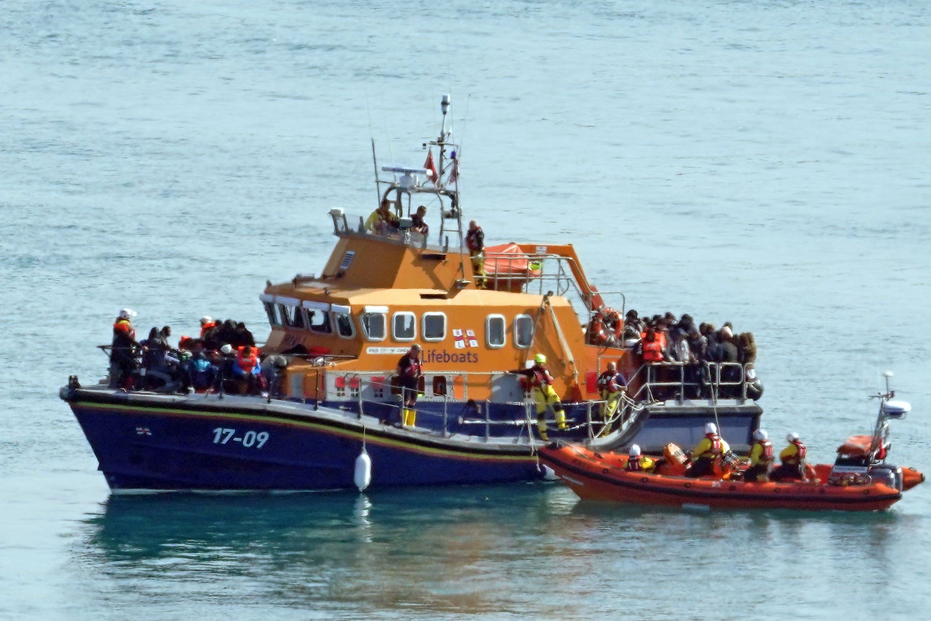 A group of people thought to be migrants are brought in to Dover, Kent, onboard the RNLI Dover Lifeboat following a small boat incident in the Channel (Gareth Fuller/PA)