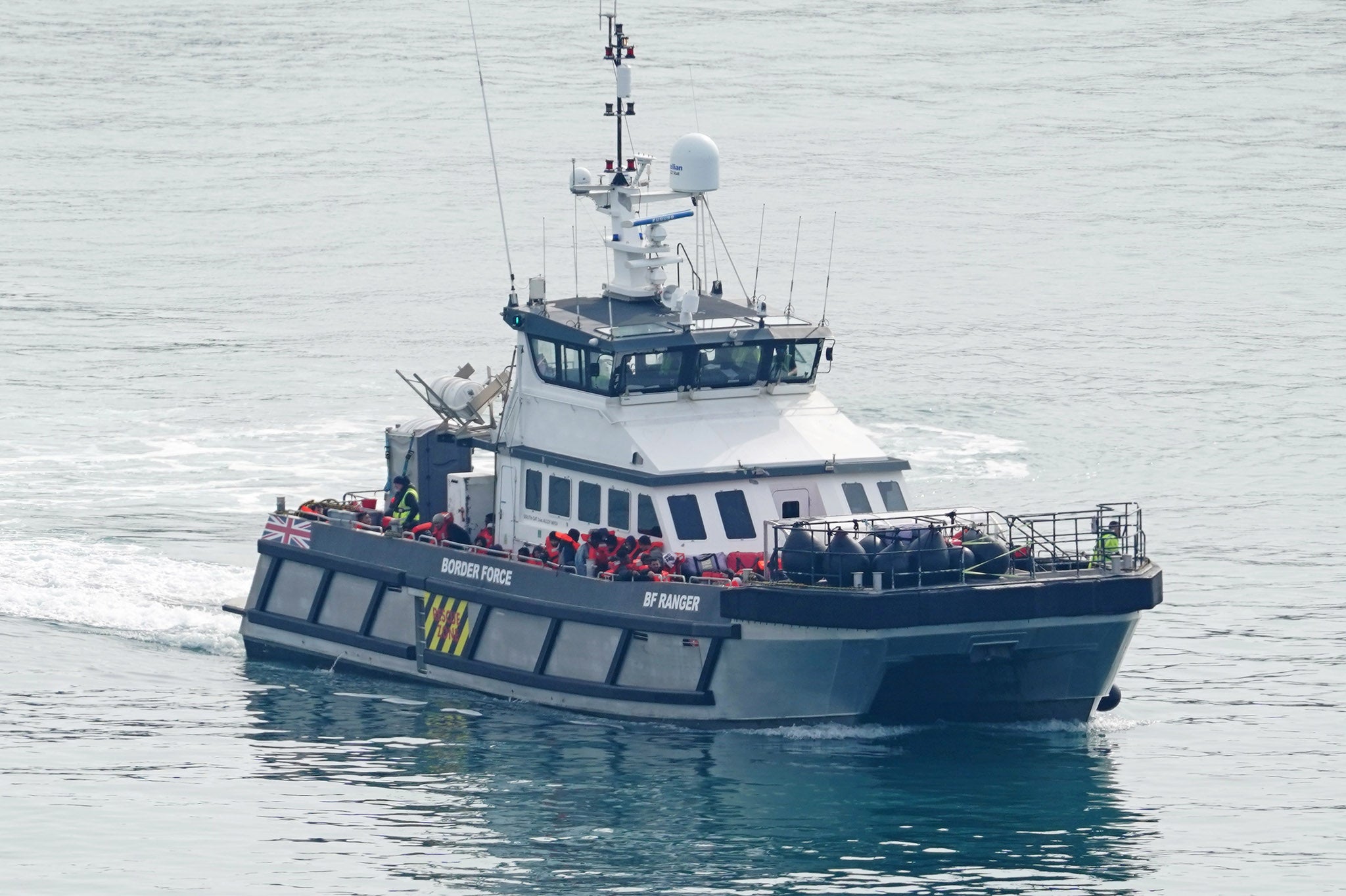 A group of migrants are taken ashore near Dover on Wednesday