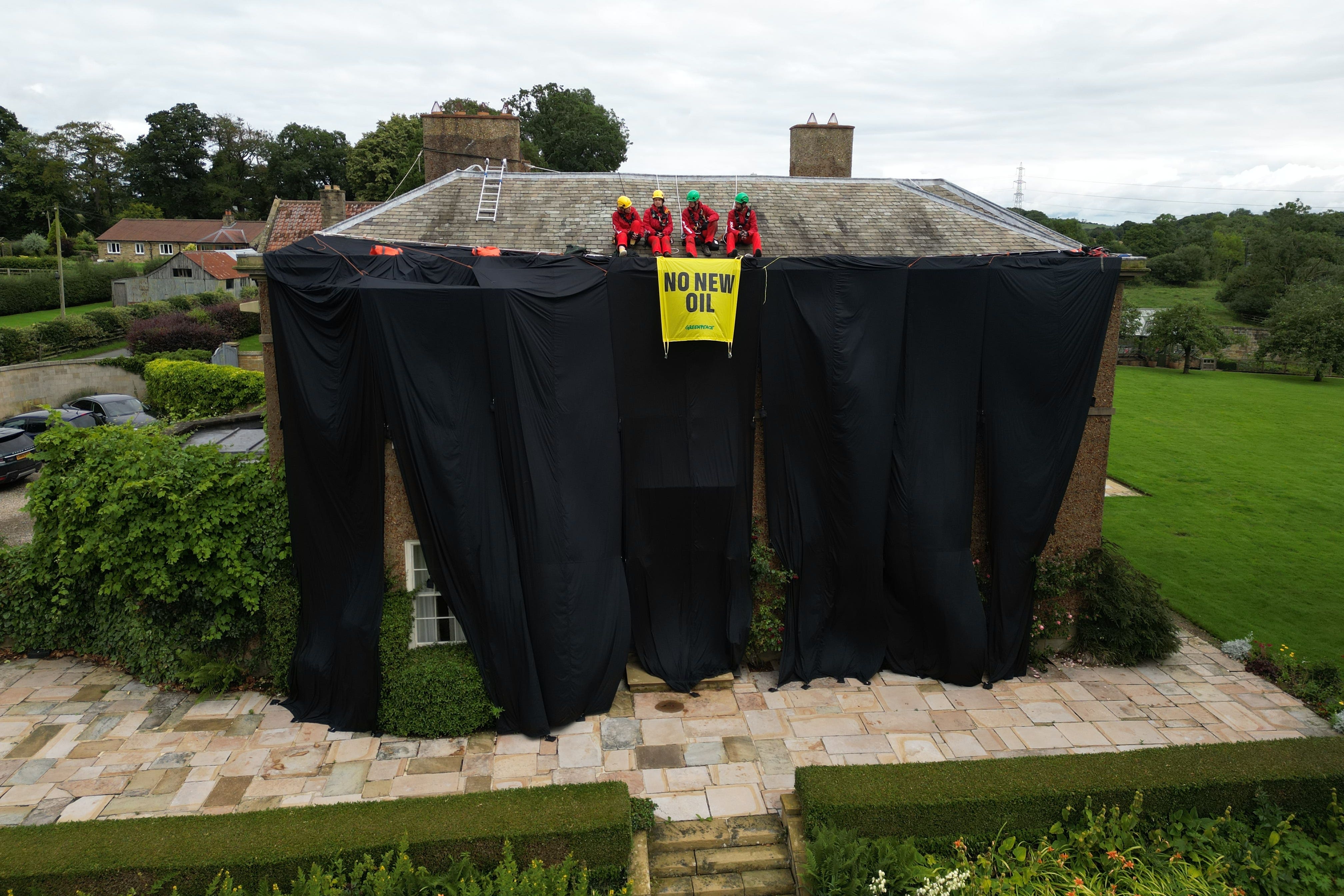 Activists on the roof of Prime Minister Rishi Sunak’s house in North Yorkshire in 2023 (Danny Lawson/PA)