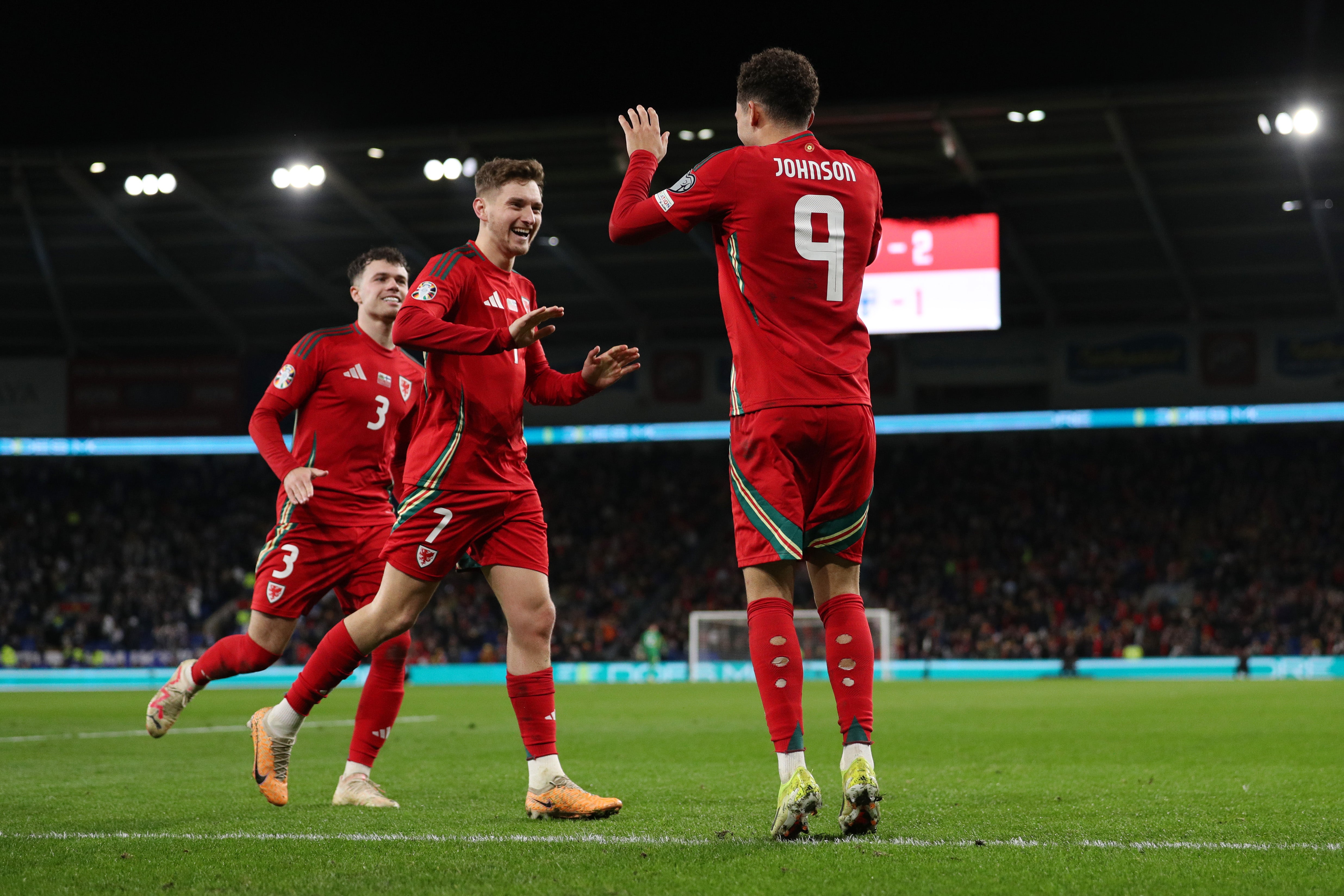 Wales celebrate their third goal of the game