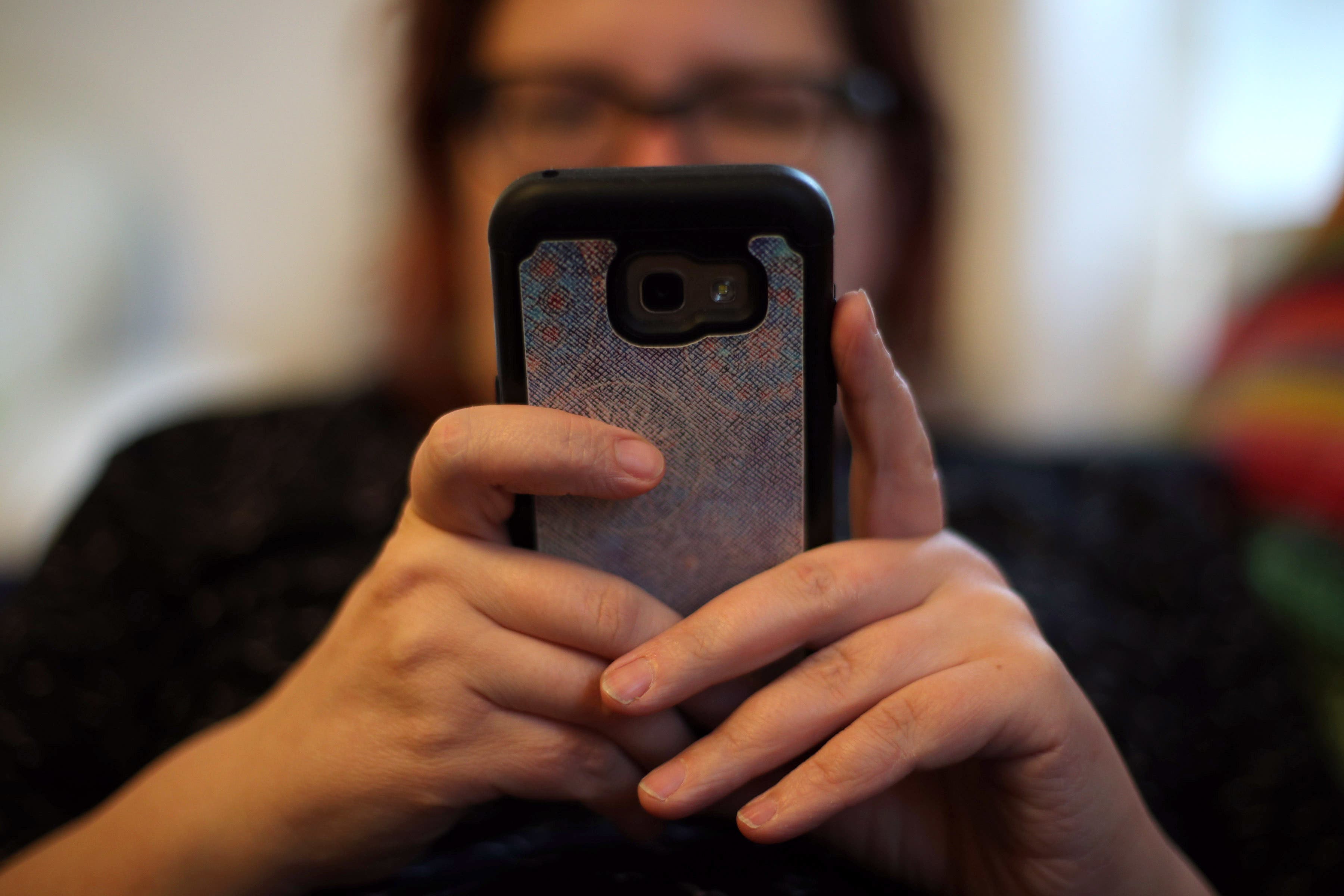 A woman using her mobile phone (Yui Mok/PA)