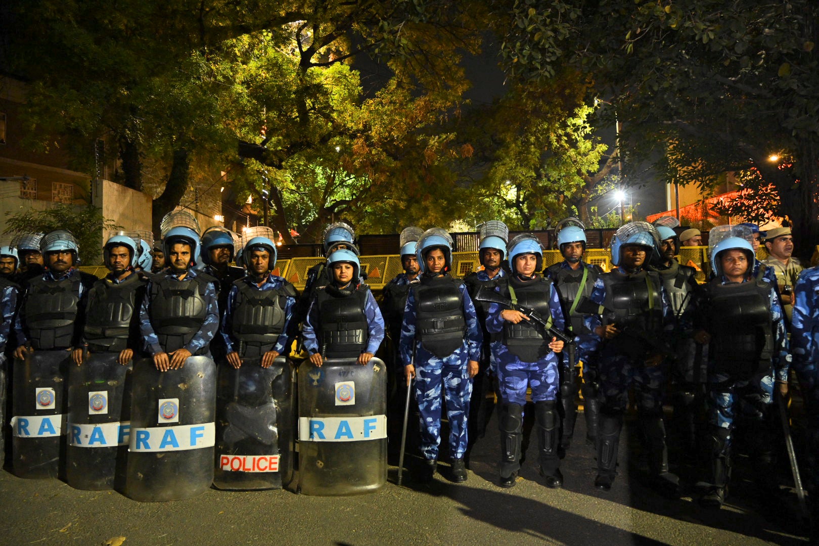 Indian Rapid Action force soldiers stand outside Aam Aadmi Party, or Common Man's Party, leader Arvind Kejriwal's residence as Enforcement Directorate