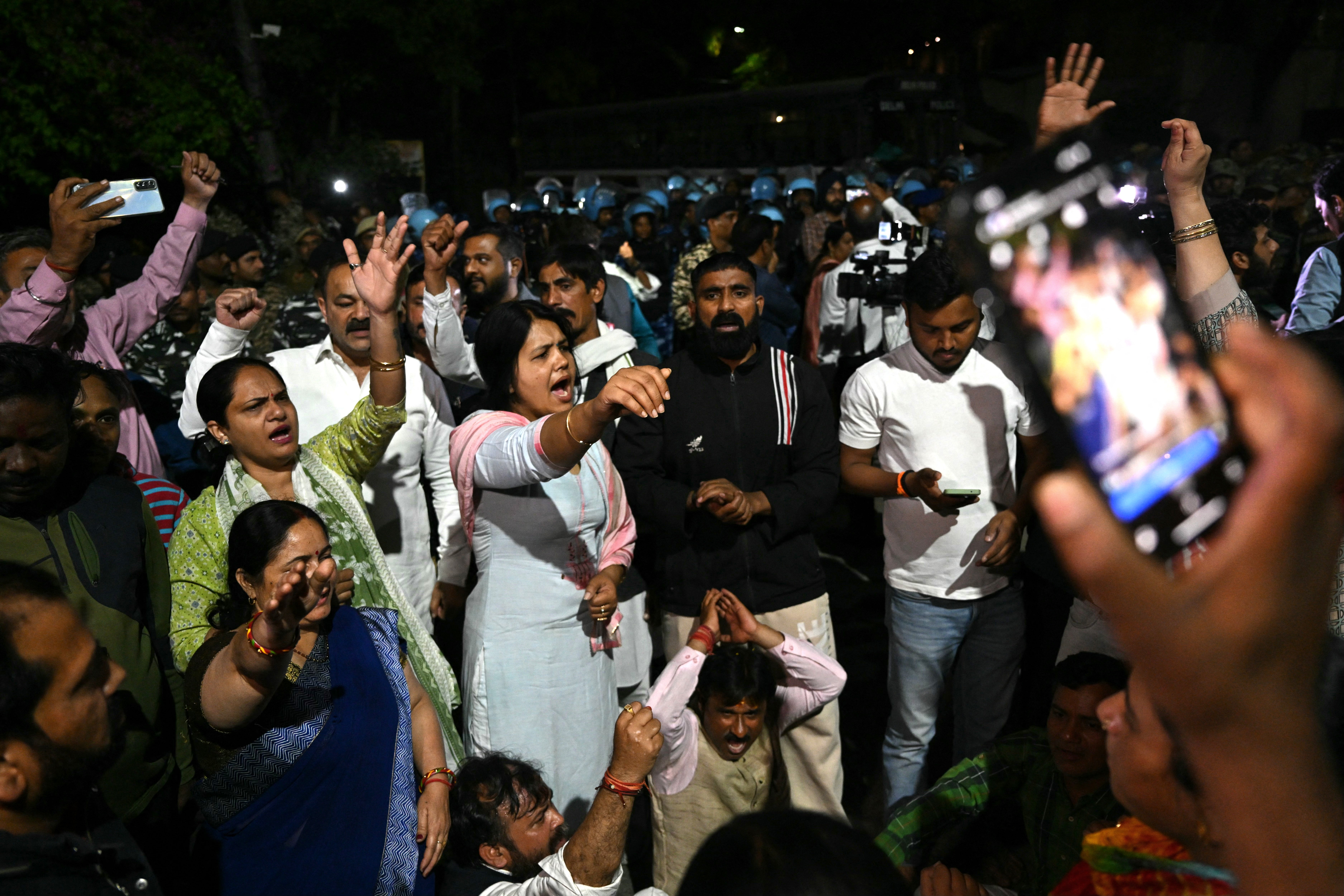 Supporters of the Aam Aadmi Party shout slogans outside in front of the home of Aam Aadmi Party chief and Delhi Chief Minister Arvind Kejriwal after he was arrested