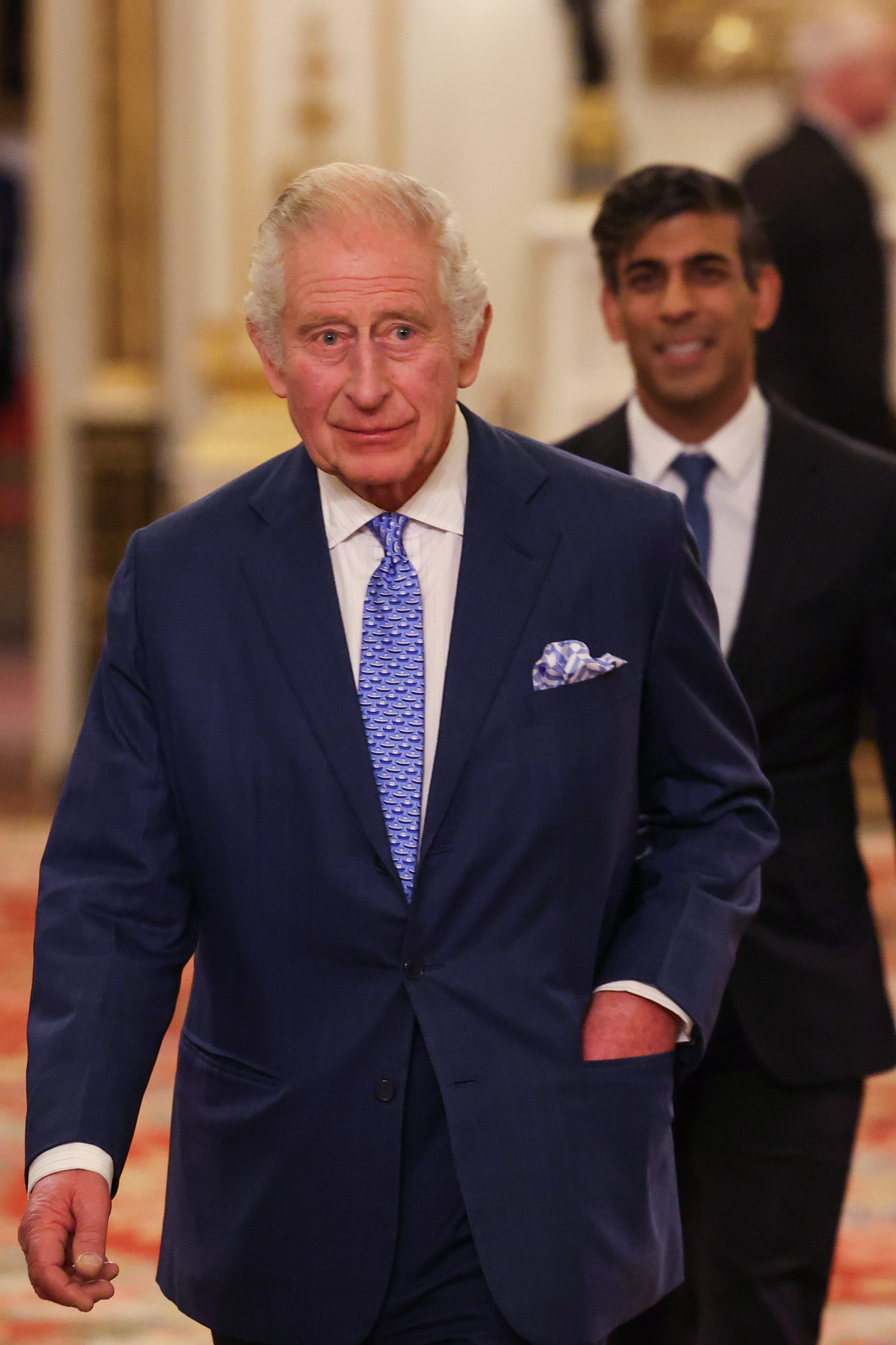 Britain's King Charles III (L) followed by Britain's Prime Minister Rishi Sunak