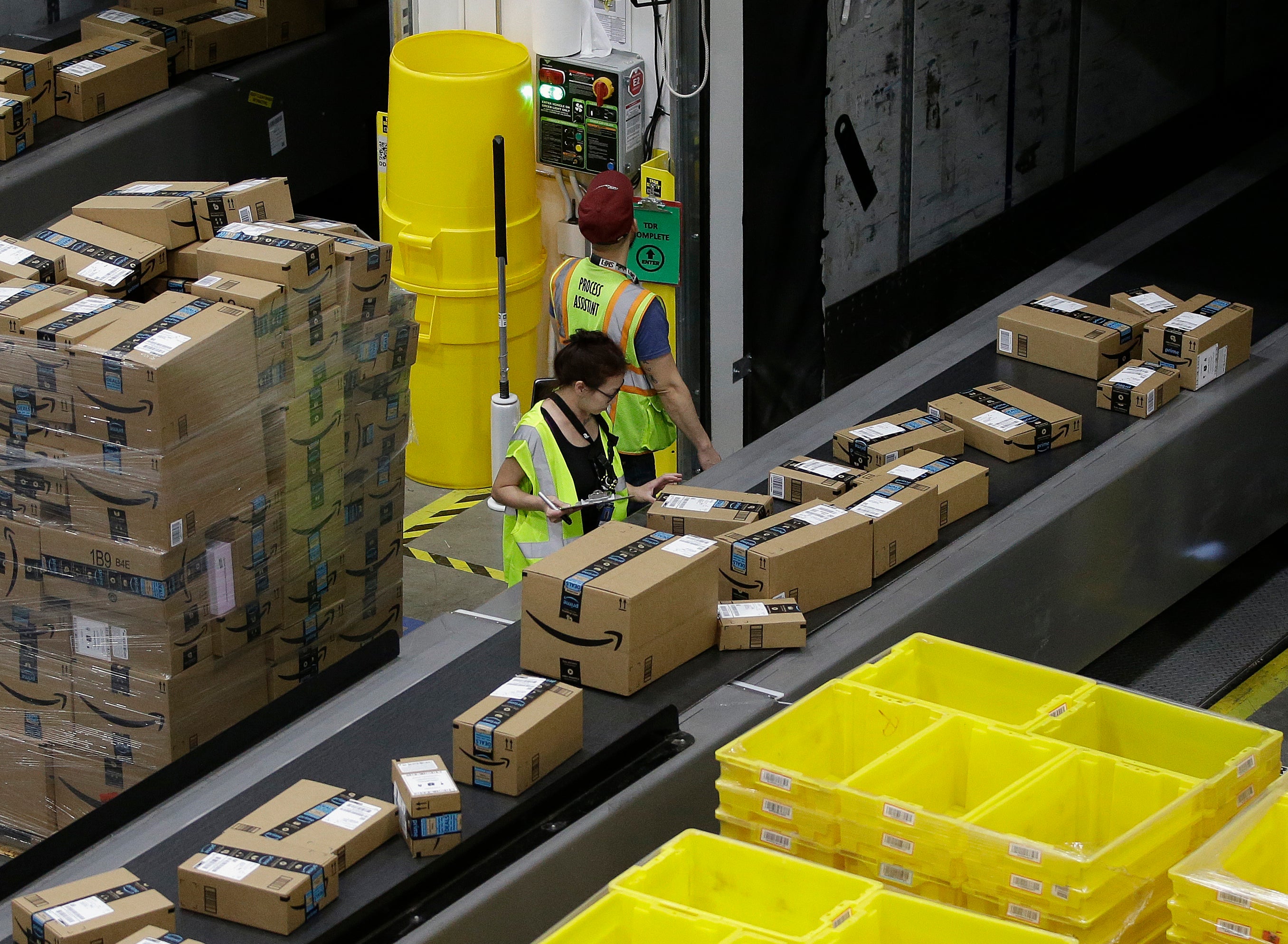 Packages move down a conveyor system were they are directed to the proper shipping area at an Amazon Fulfillment Center in Sacramento, California. A new Senate report found that just under half of Amazon’s warehouse workers are injured around the company’s Prime Day event