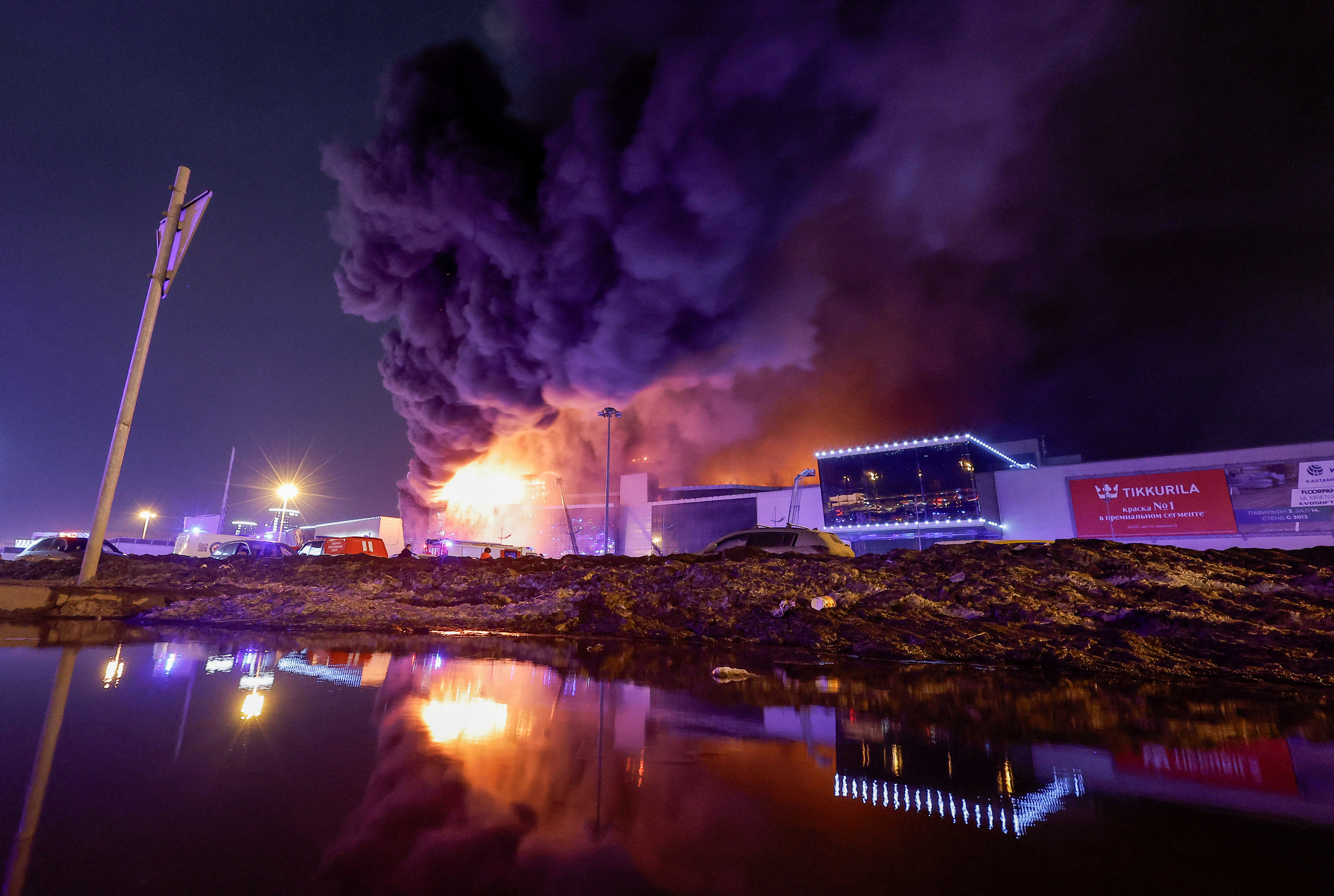 Smoke from fire rises above the burning Crocus City Hall concert venue following a shooting incident, outside Moscow, Russia, 22 March 2024.